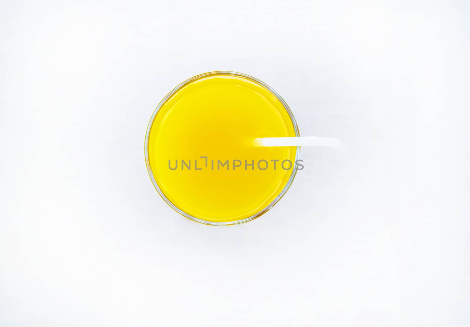 Summer drink - freshly squeezed orange juice in a glass with straw tube, top view, isolated on white background, minimalism style by claire_lucia