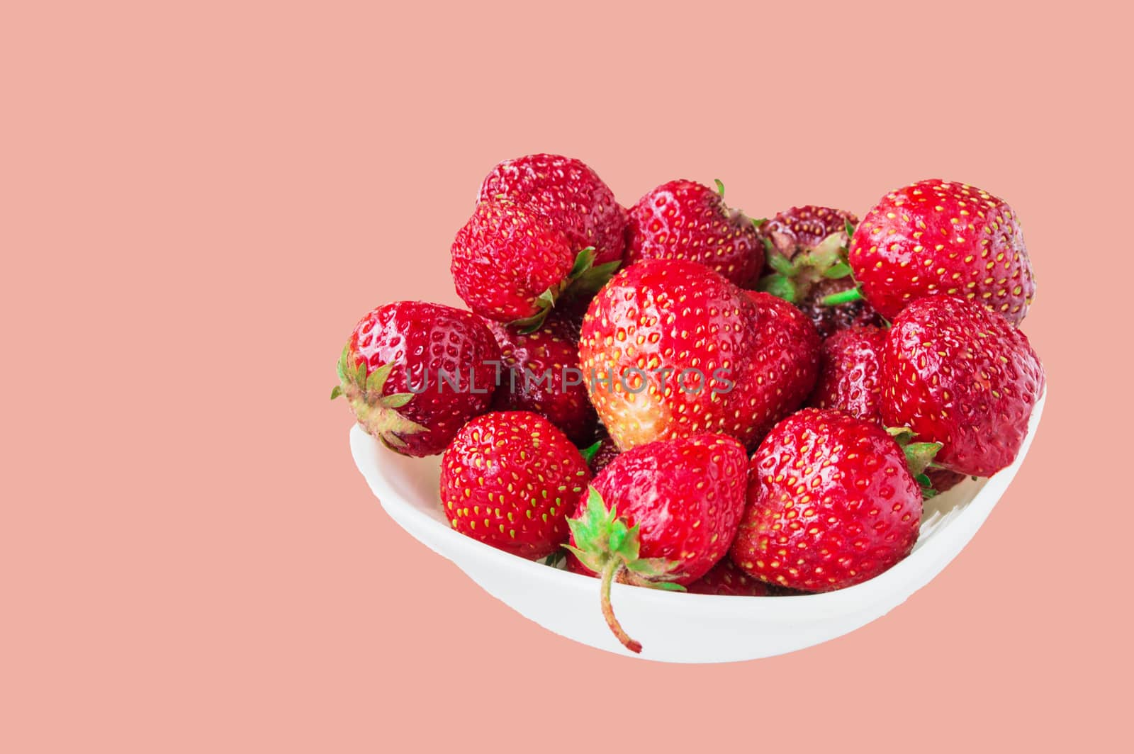 Glass bowl with fresh ripe strawberries, space for text, copy space isolated on pink background, layout, clipping.