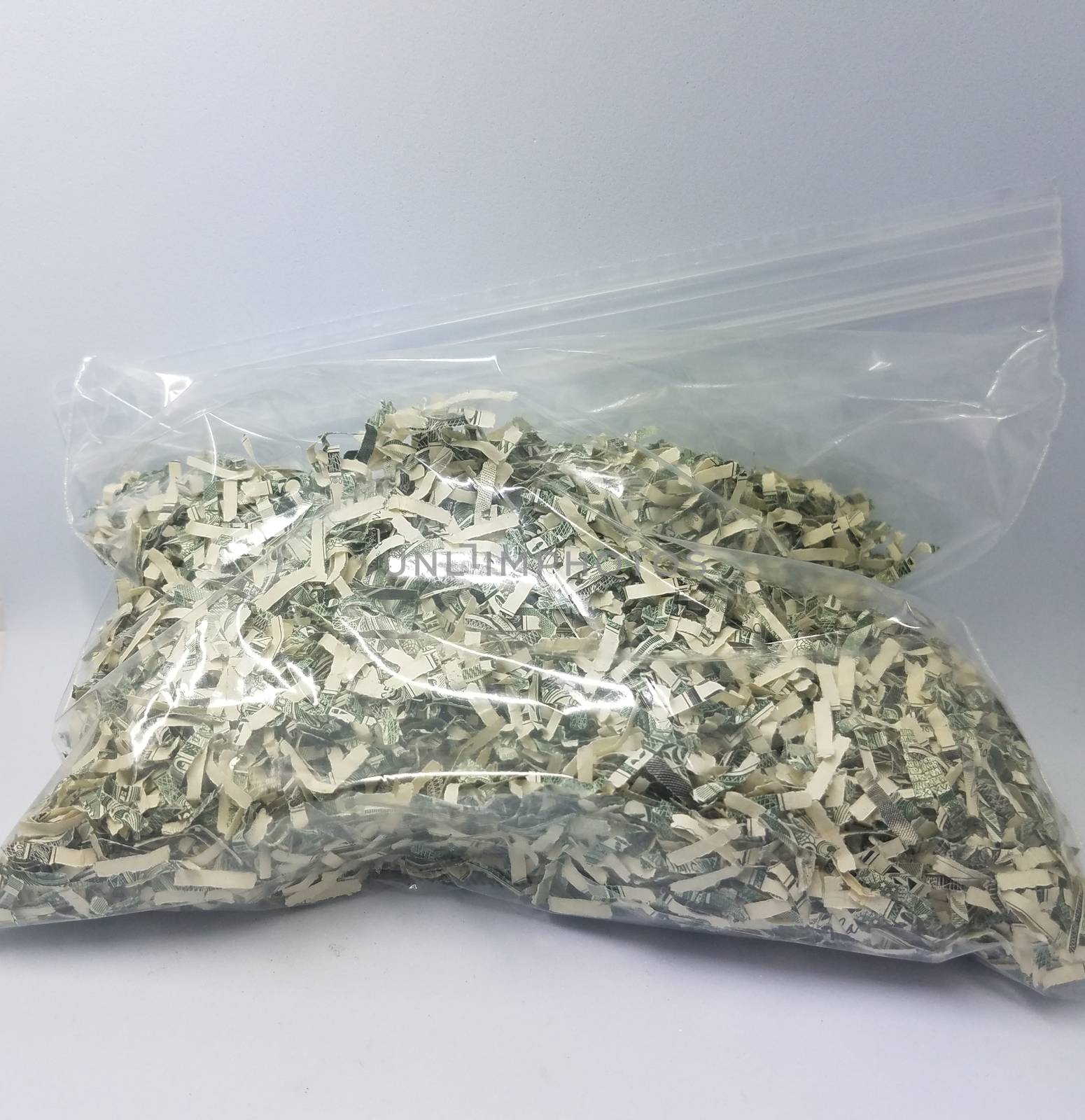 plastic bag of shredded united states dollar bills by stockphotofan1