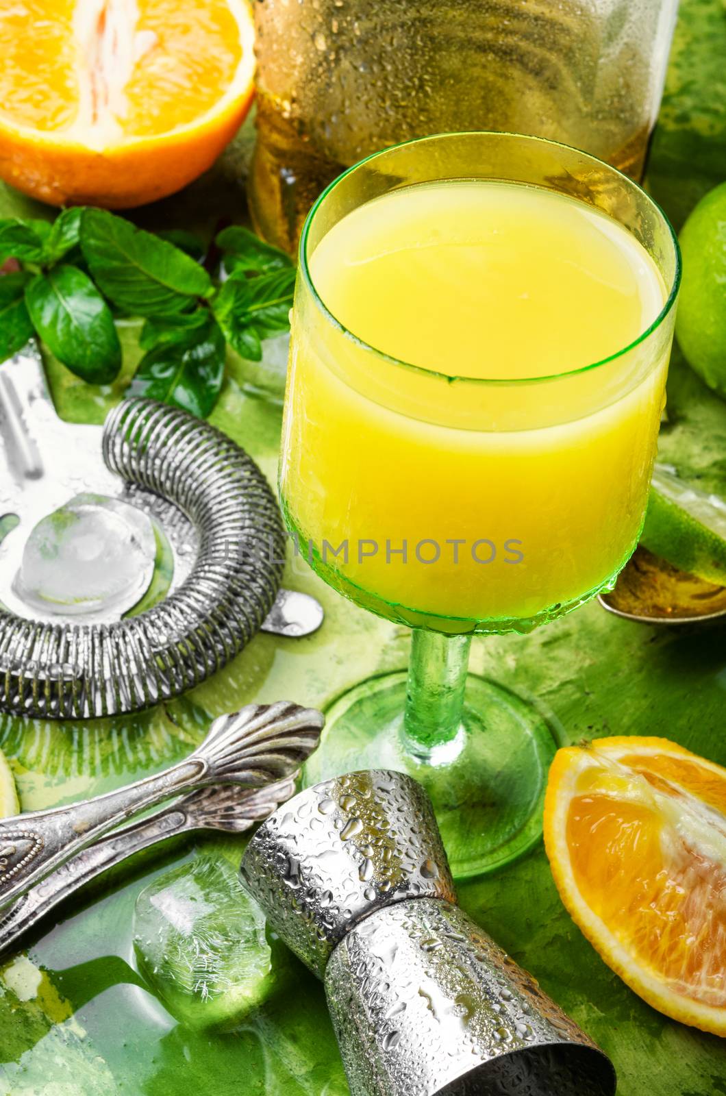 Orange cocktail with lime slice and ice.Glass of orange drink