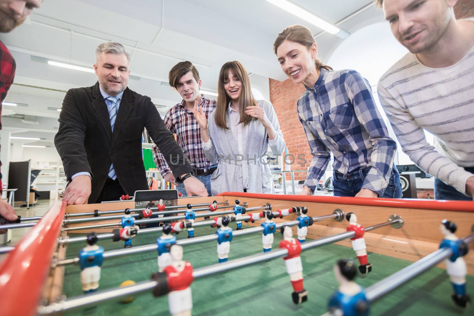 Employees playing table soccer by Yellowj