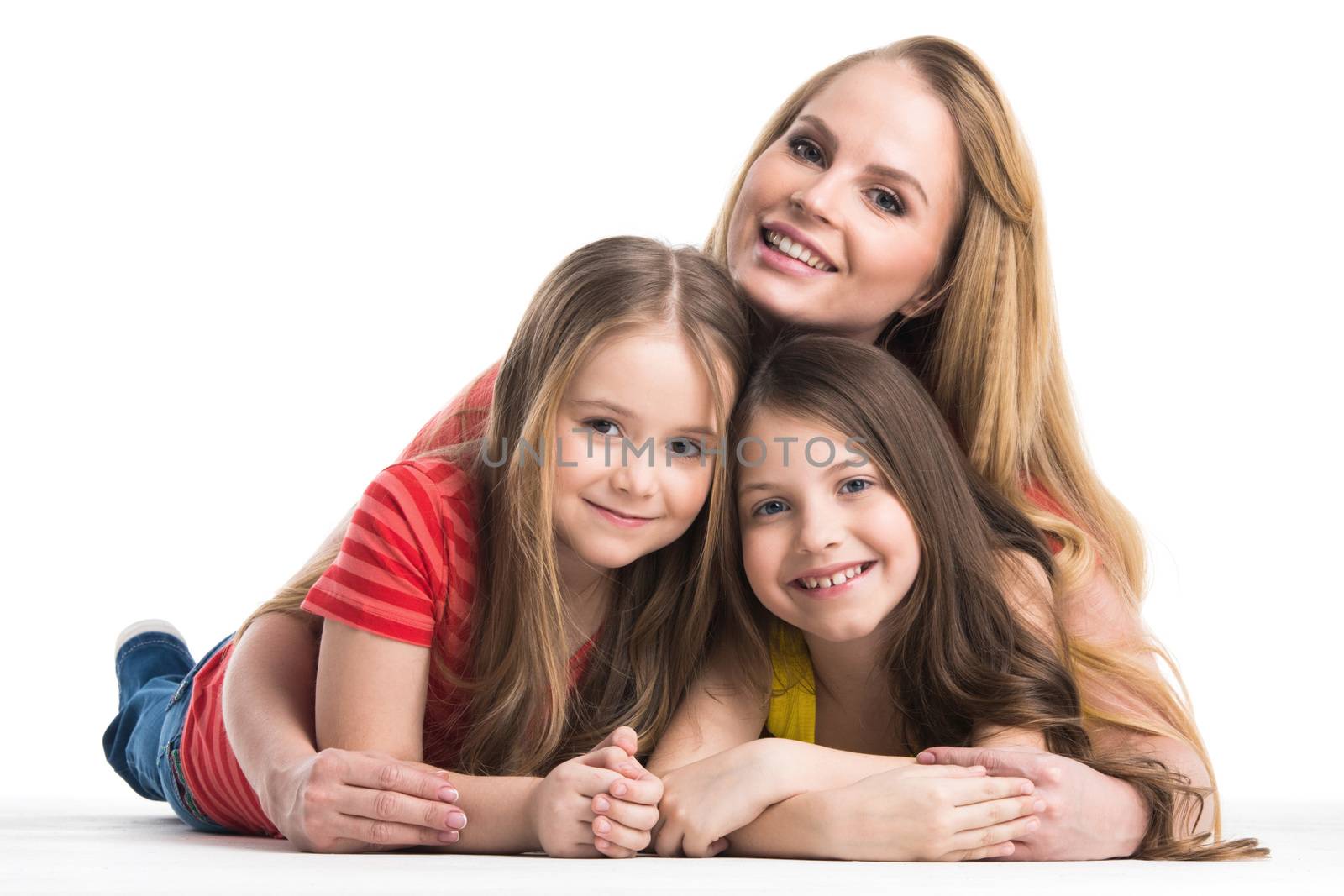 Mother and her daughters lying and smiling studio isolated on white background