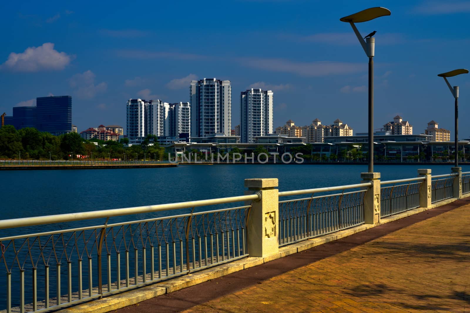 Putrajaya lake promenade with residential area and skyscrapers