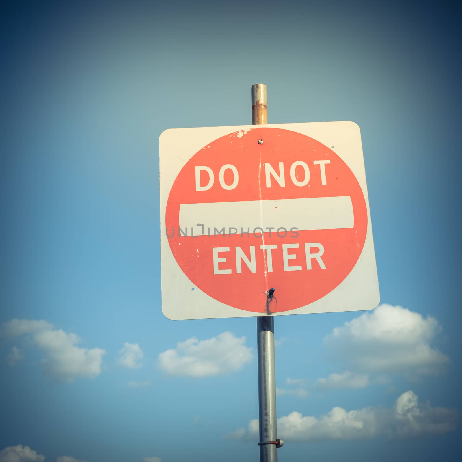 Filtered image close-up low angle view of do not enter sign under cloudy sky by trongnguyen