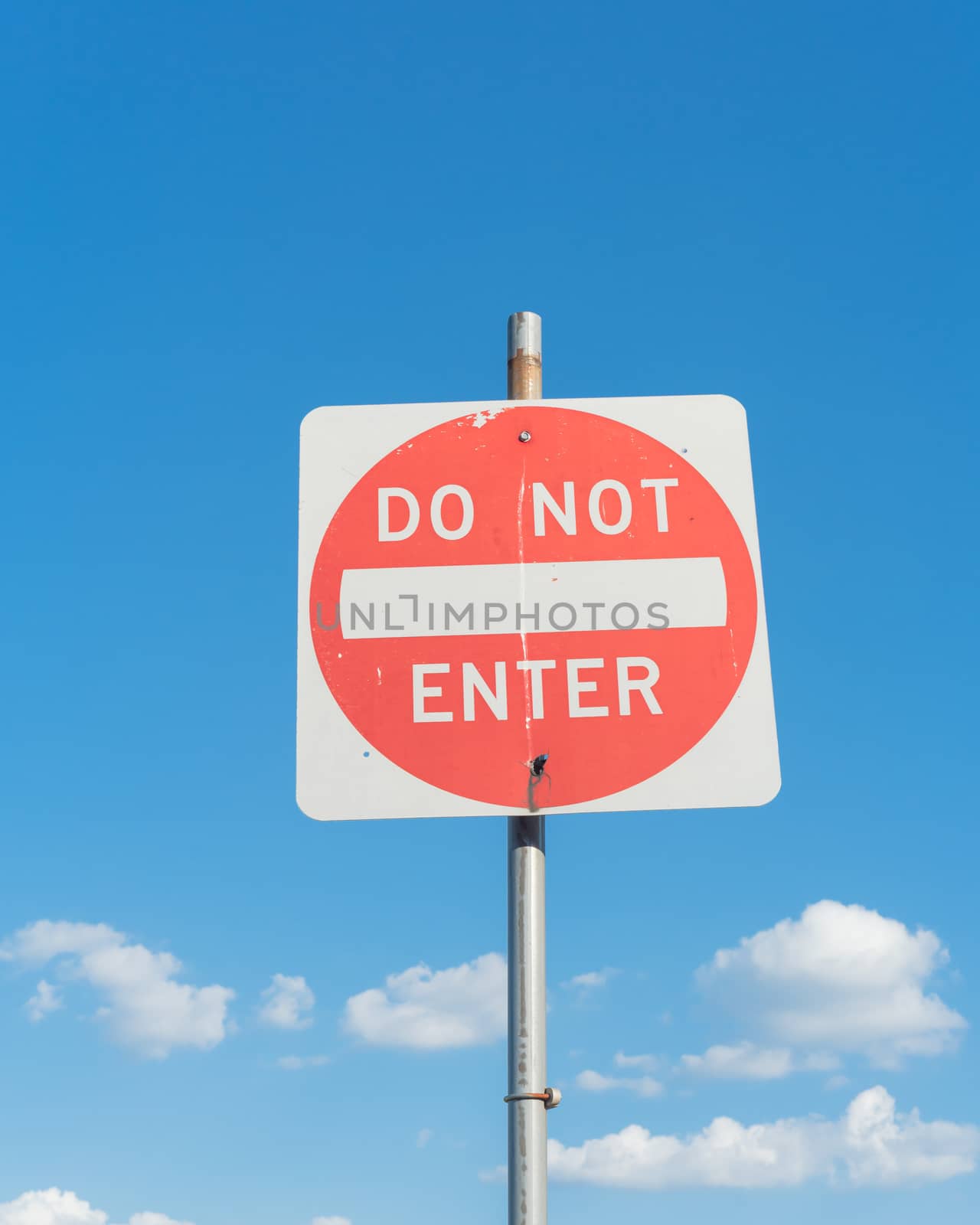 Close-up low angle view of do not enter sign under cloudy sky by trongnguyen