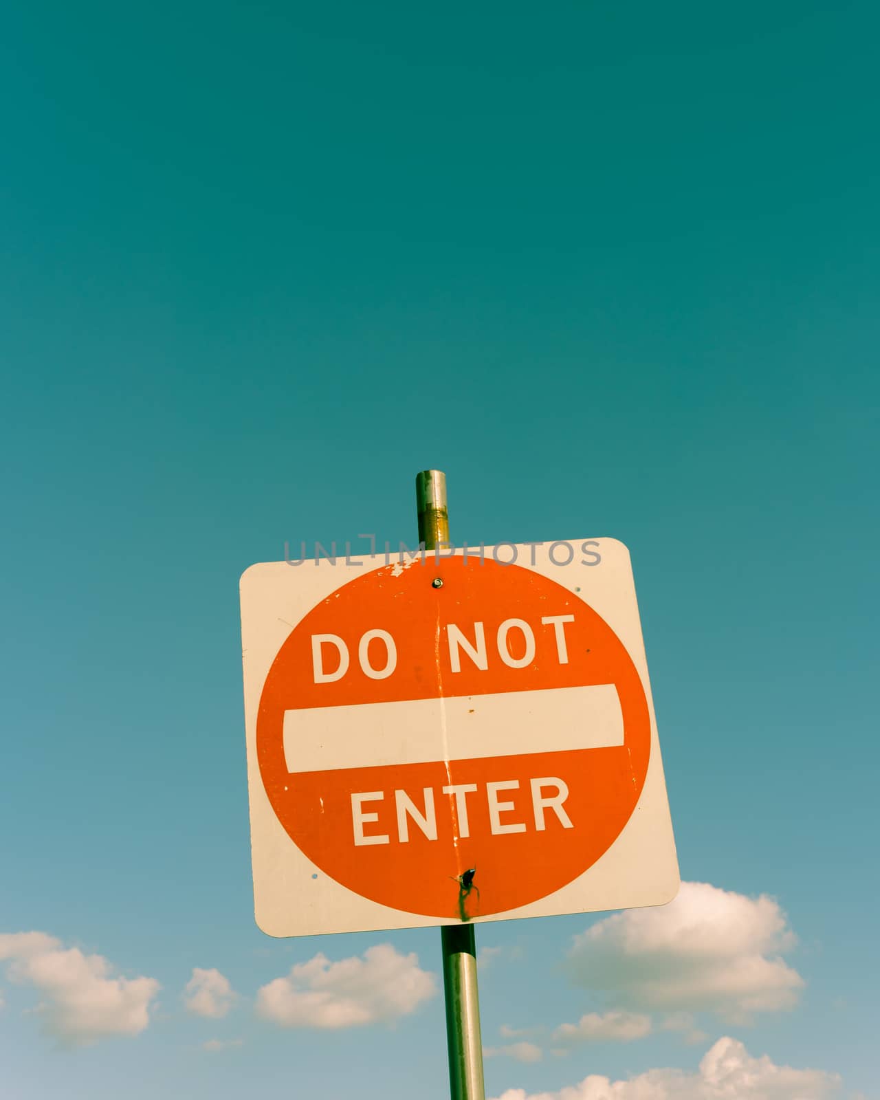 Filtered image close-up low angle view of do not enter sign under cloudy sky by trongnguyen