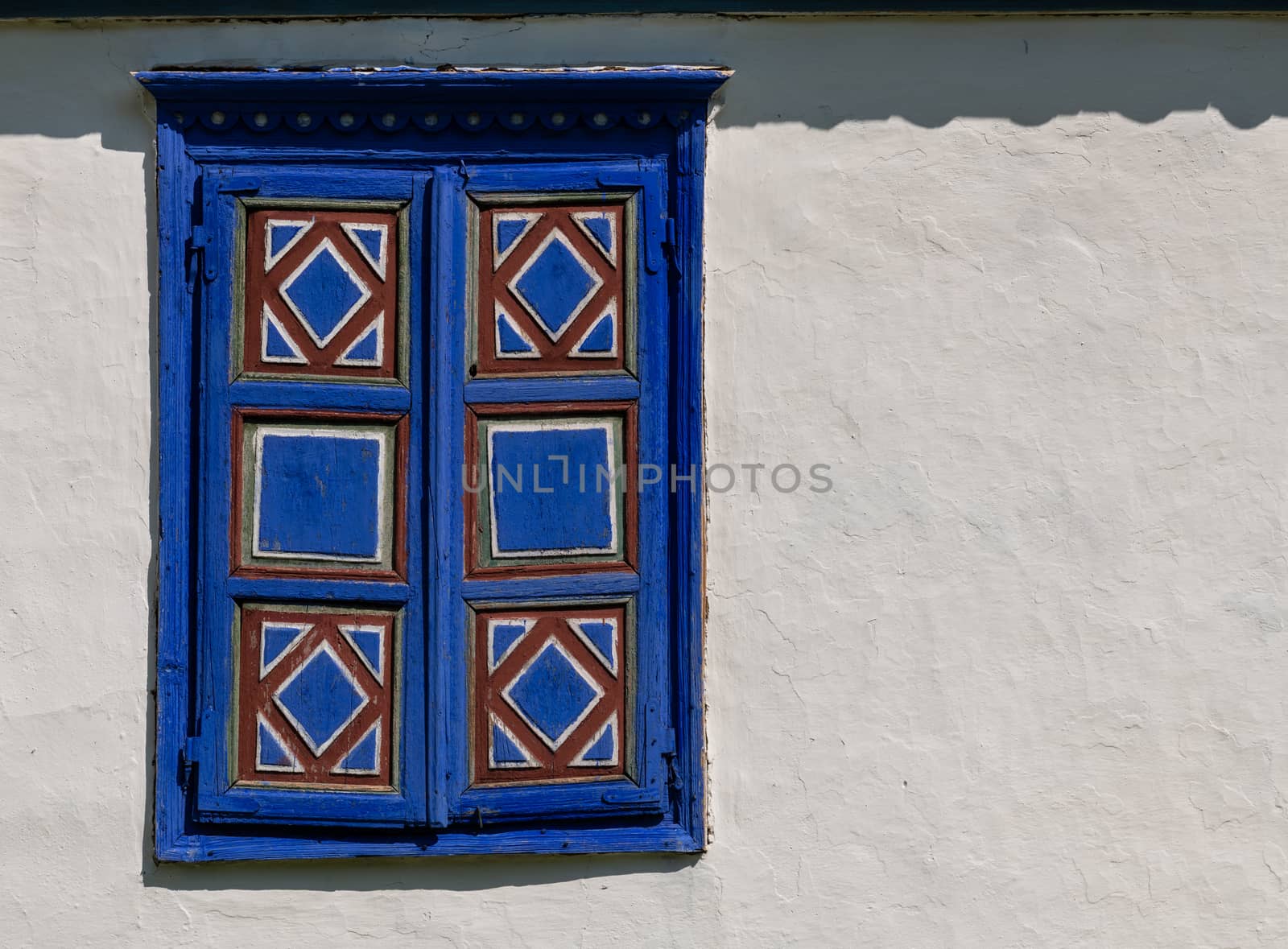 White Mud Wall with Blue Window by viscorp