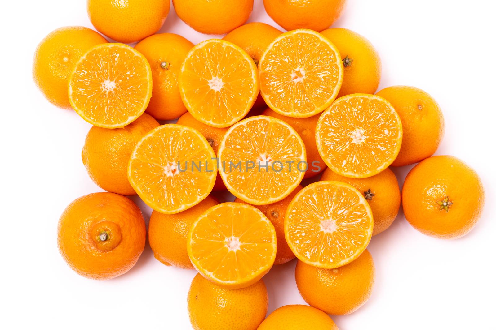 Top view of round cut slices of ripe juicy organic mandarin oranges on a white background. Vitamins healthy lifestyle vegan super foods concept.