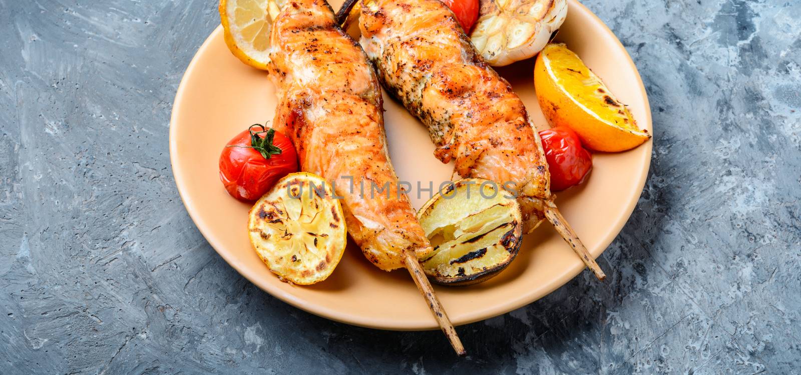 Grilled fish, grilled salmon steak with addition of lemon