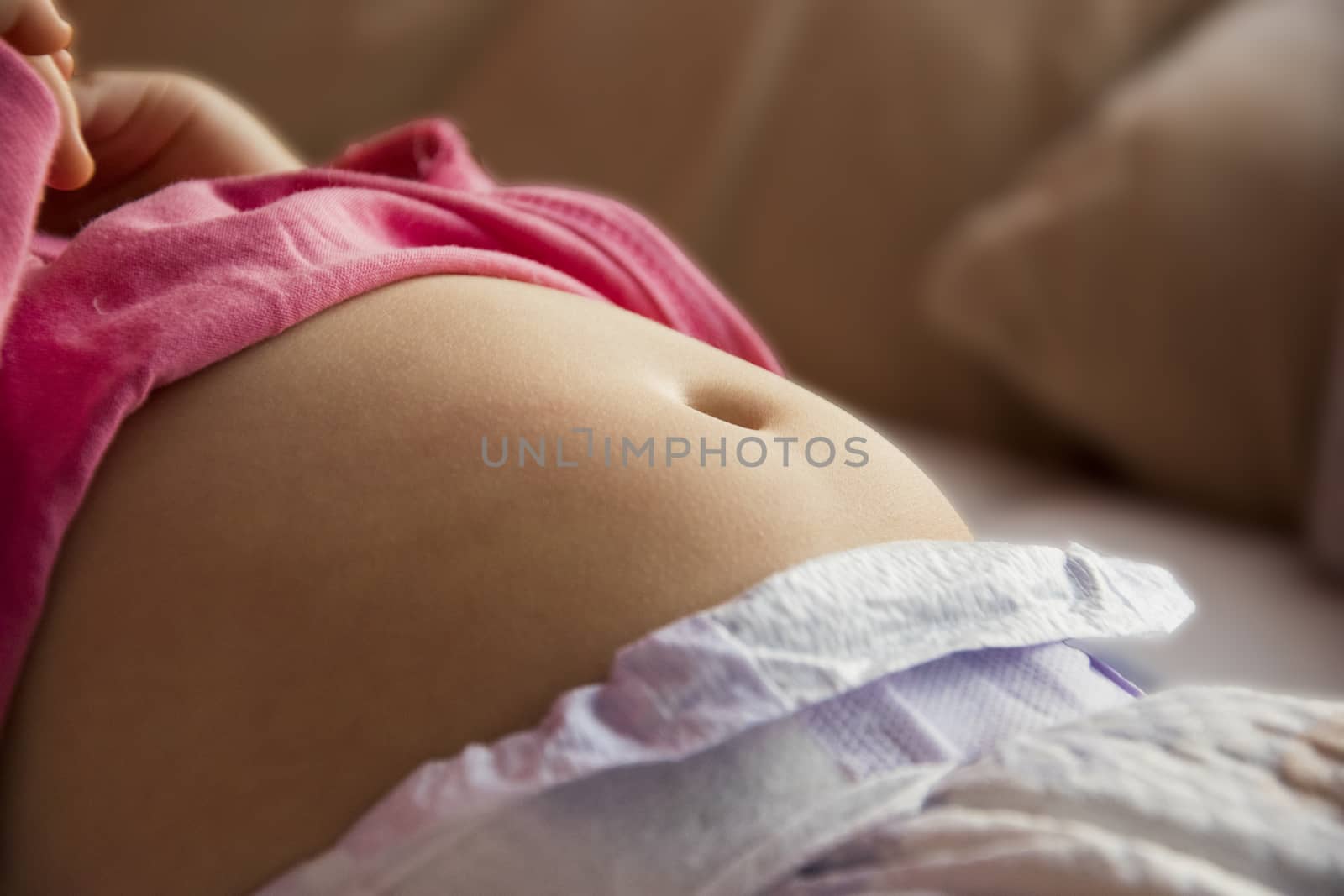 belly, tummy of a small child close up photo. young skin with a visible navel