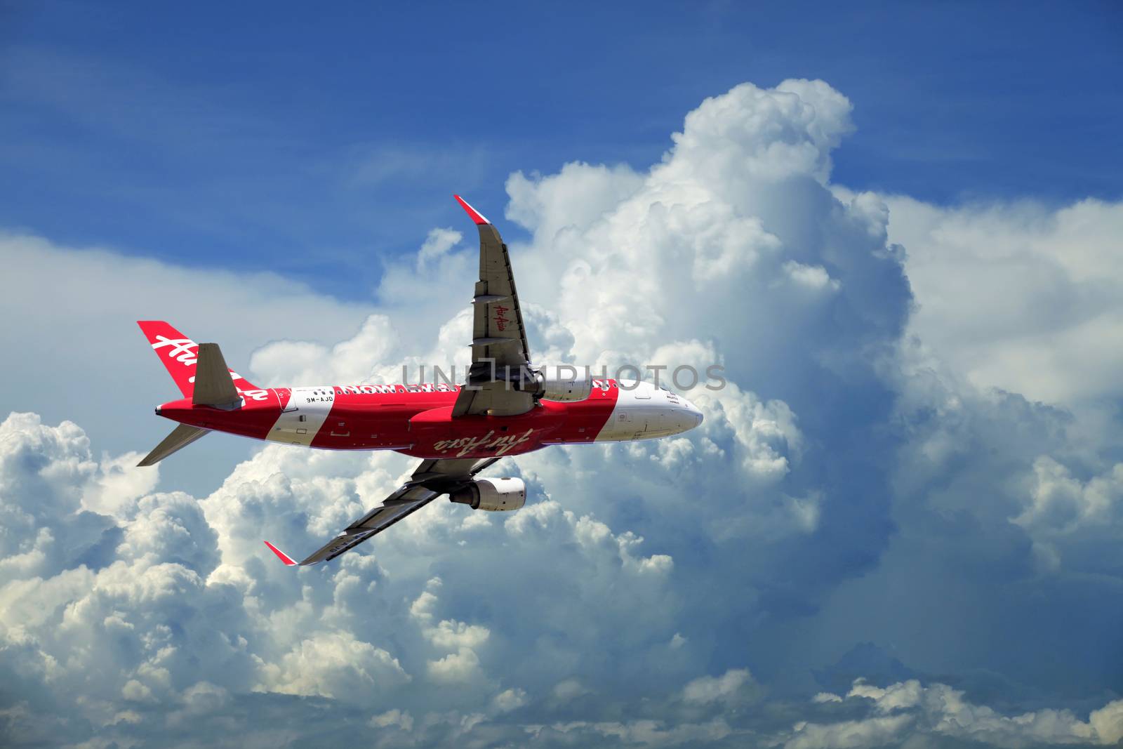 Kota Kinabalu, Malaysia - January 03, 2015: Passenger airplane Airbus A320 flying travel, trip at flight level over the white clouds 