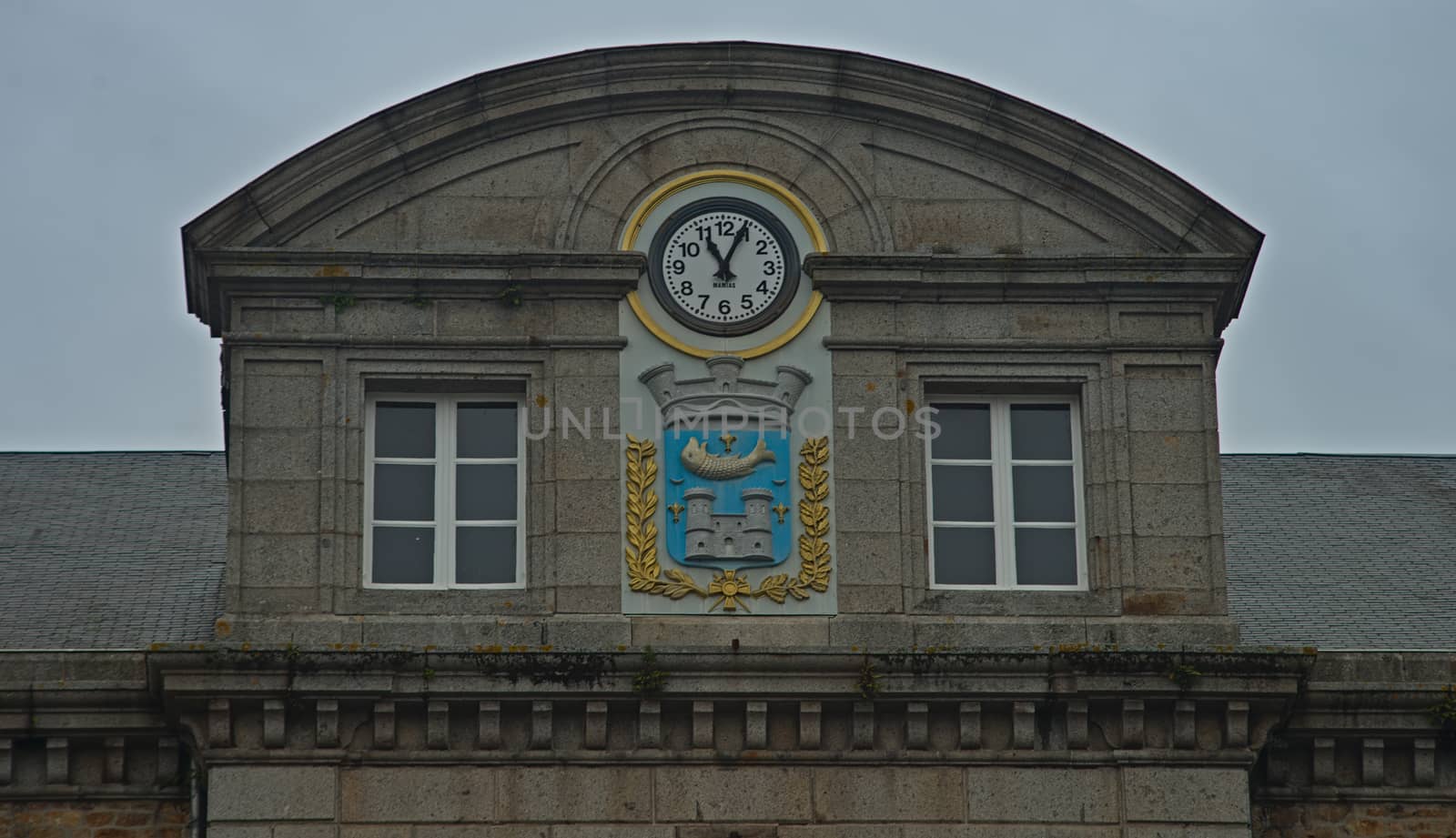 Domed building top with clock and coat of arms at Avranches, France