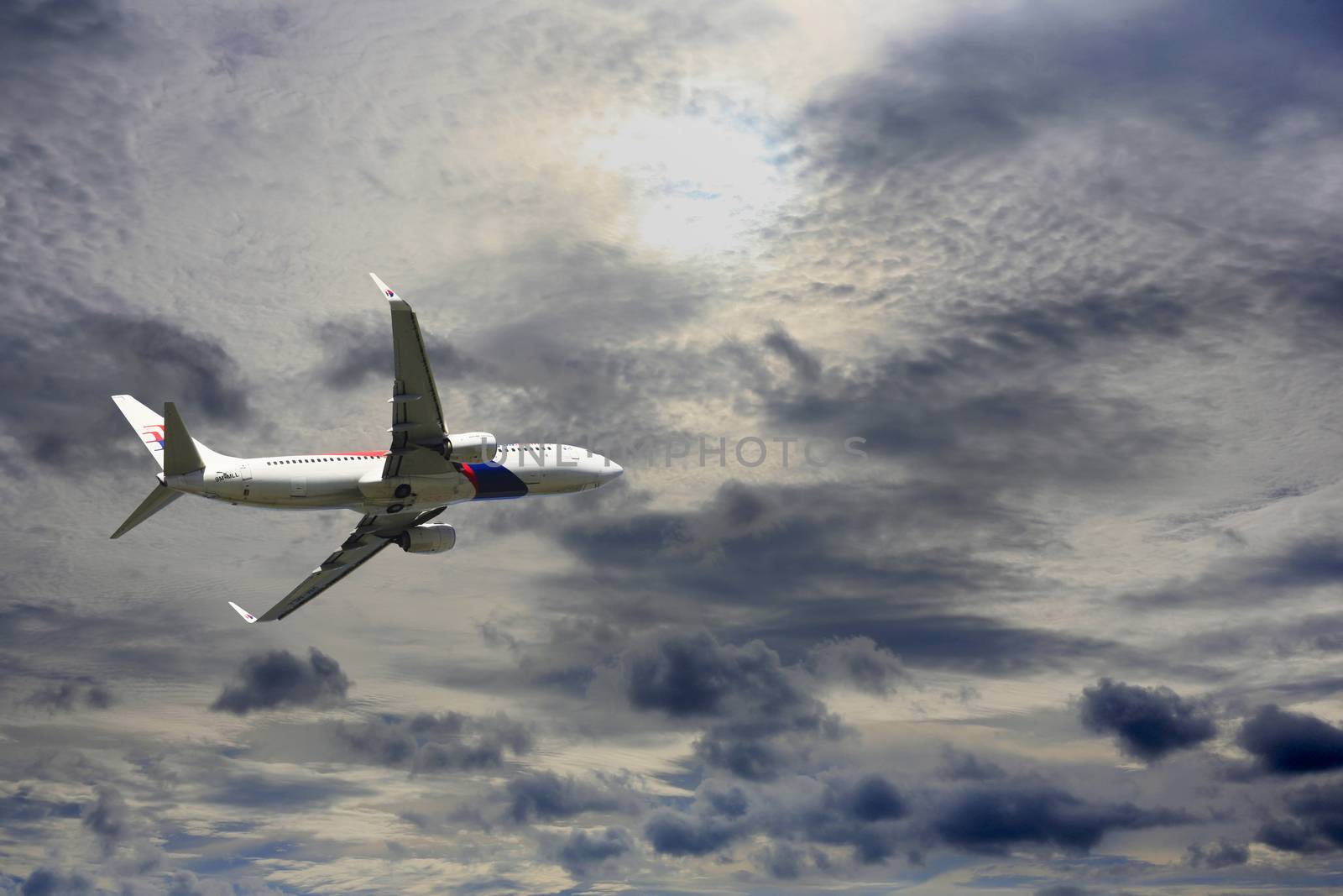 Kota Kinabalu, Malaysia - January 03, 2015: Passenger airplane Boeing 737-4H6 flying travel, trip at flight level over the white clouds       