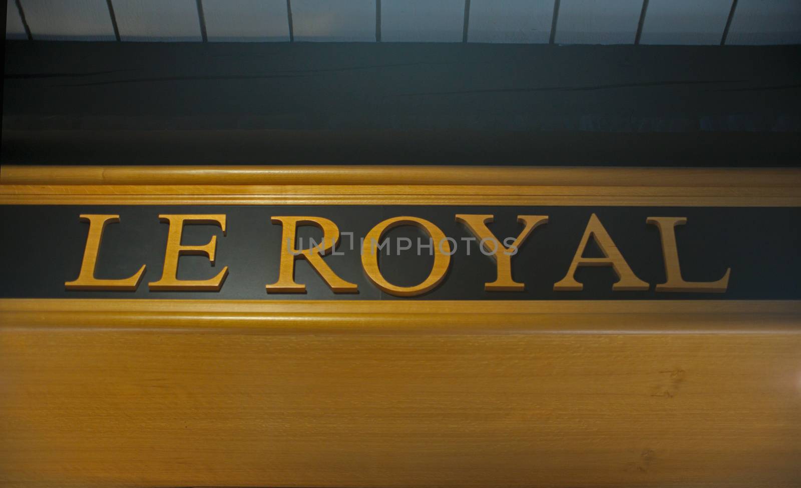 Elegant indoor logo Le Royal at wooden sealing