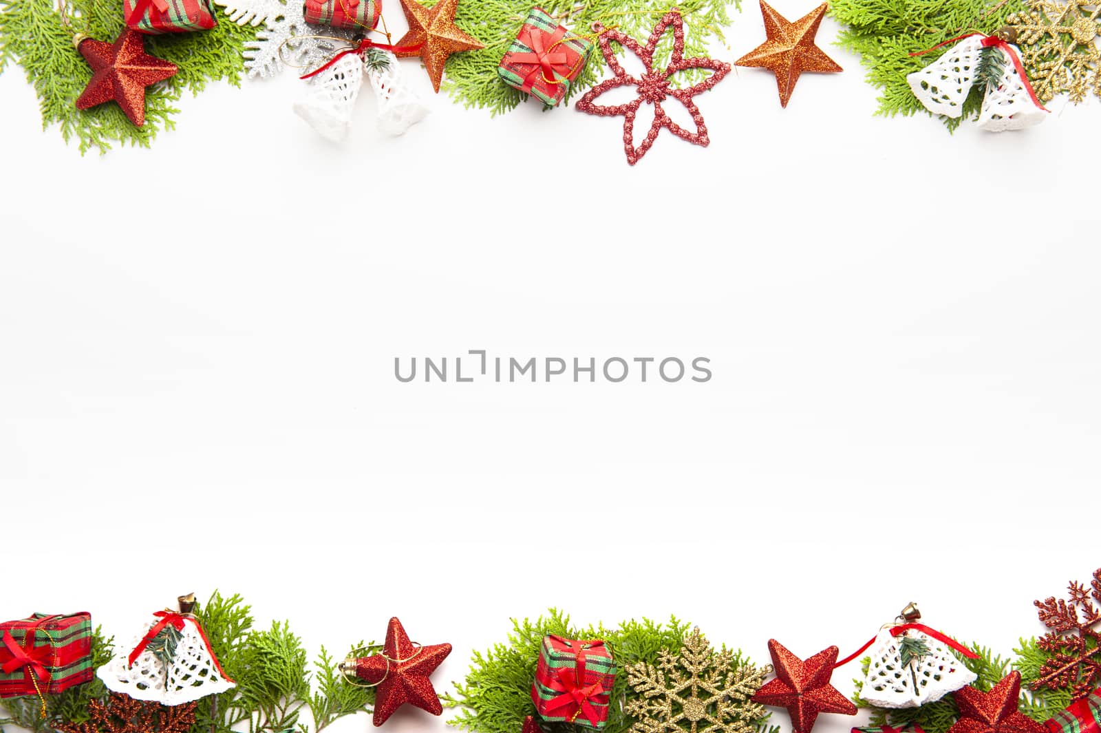 Top view of Christmas background, template with decorations of balls, gift boxes, white bells on fir tree on with white background with copy space, ornaments for new year greetings.