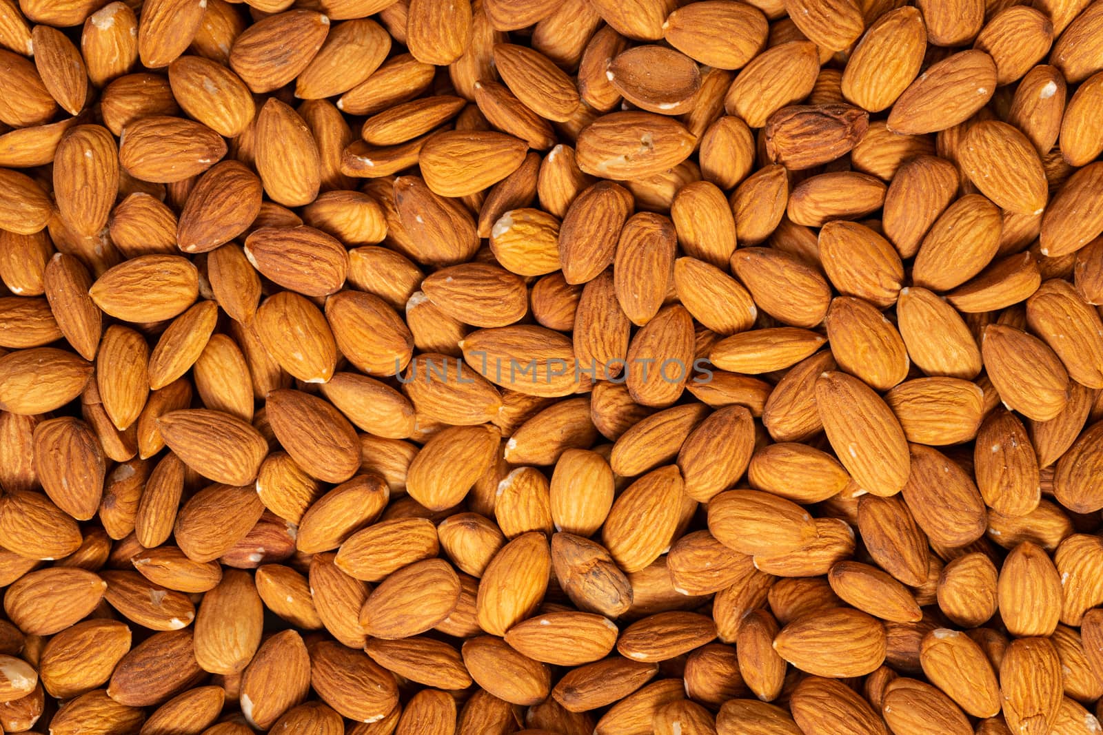 Food texture background of big raw peeled almonds , top view.
