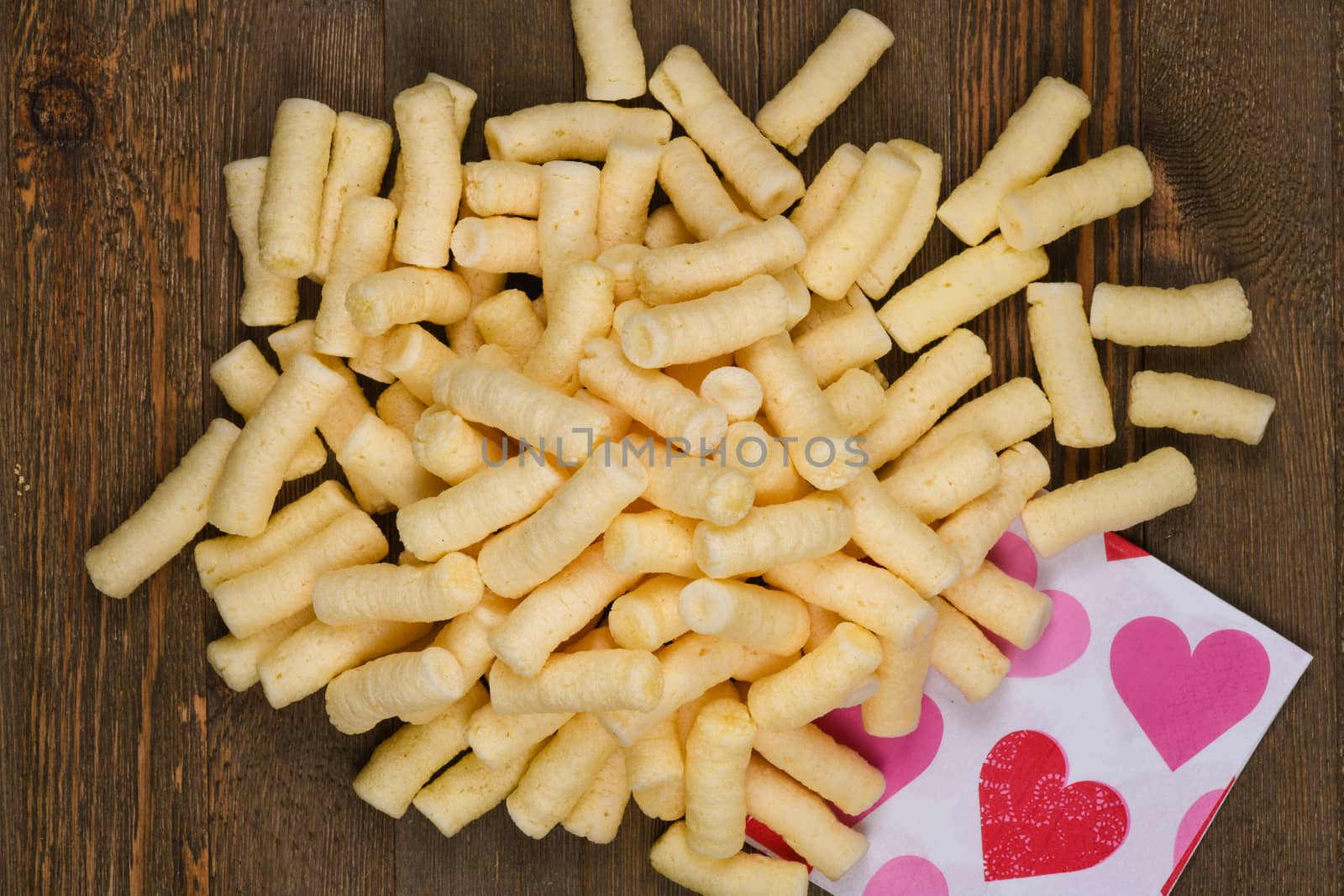 Corn puffs snack food texture background, close up detail.