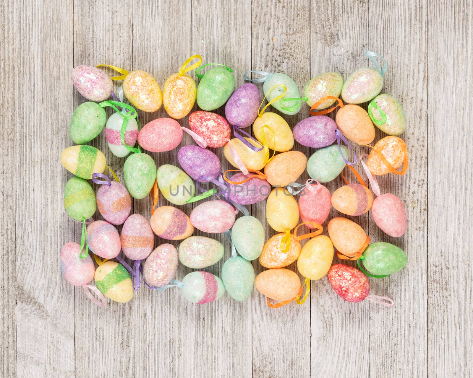 Happy Easter colorful foam eggs on a wooden background.