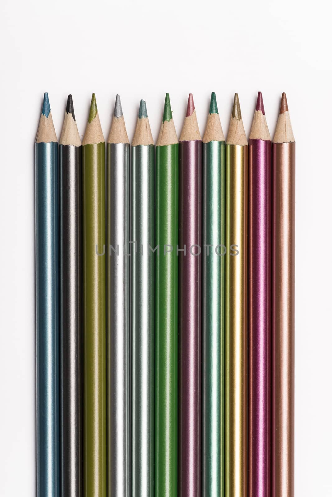 Set of metallic colored pencils isolated on a white background.