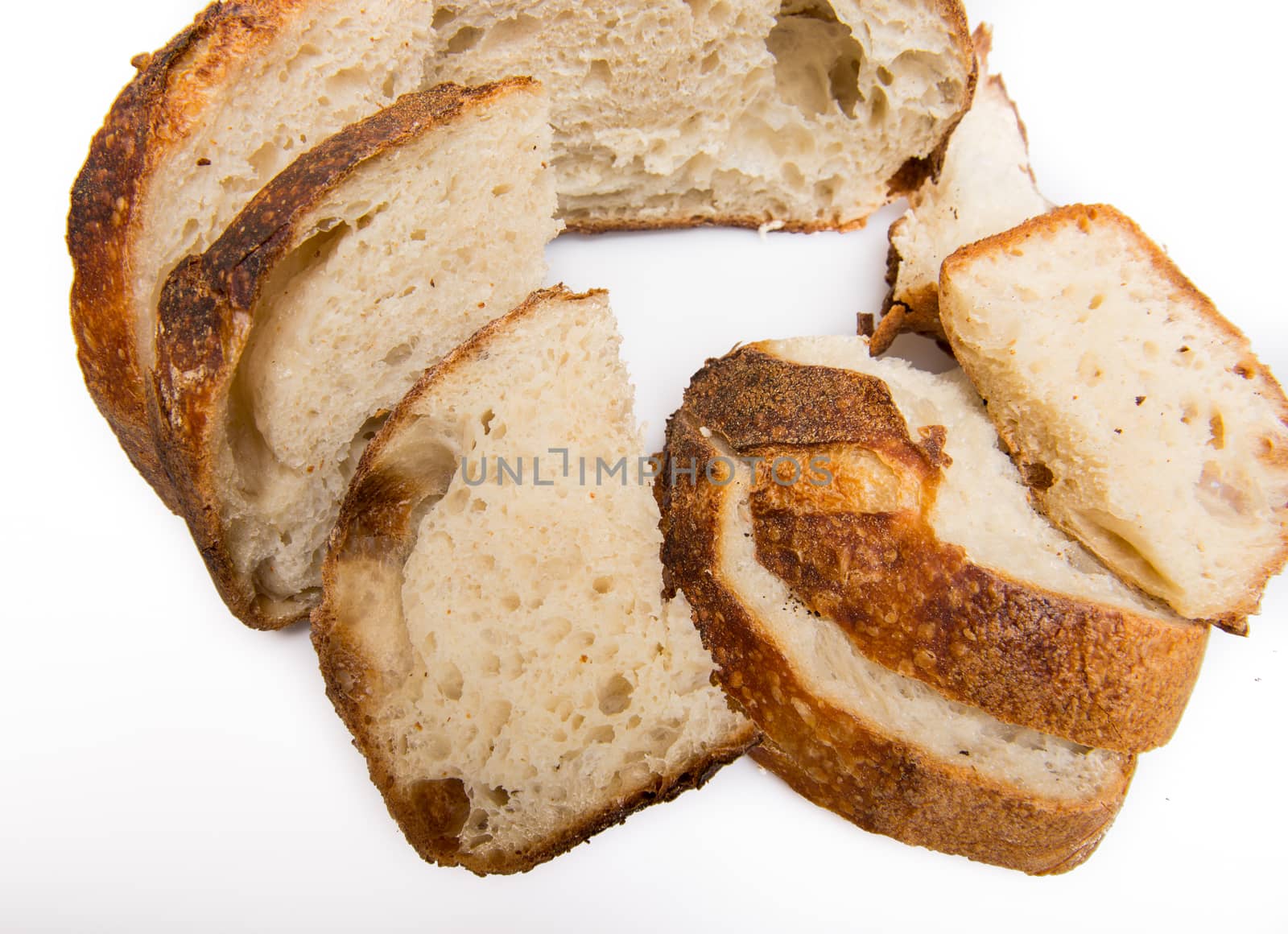 Freshly cut slices of white artisan sourdough bread on isolated a white background.