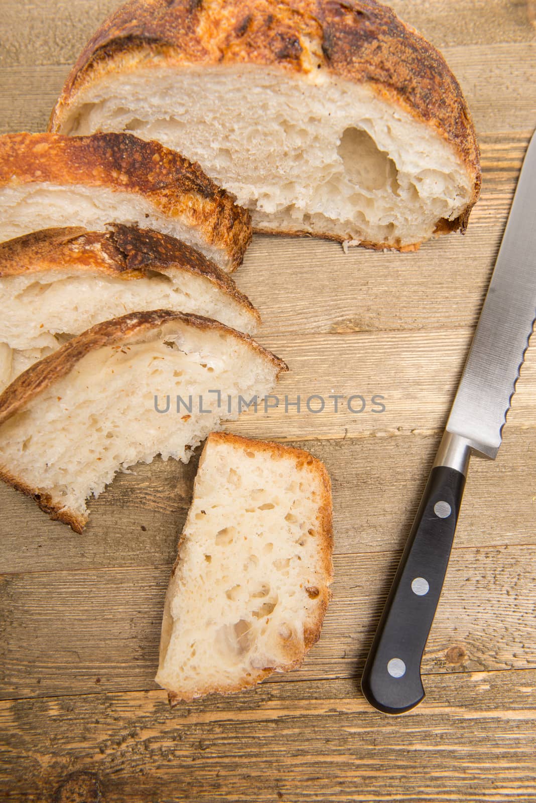 Freshly cut slices of white artisan sourdough bread on isolated a white background.