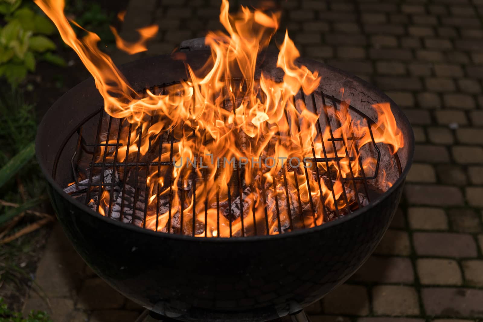 Close-up of blazing fire in BBQ grill at evening.
