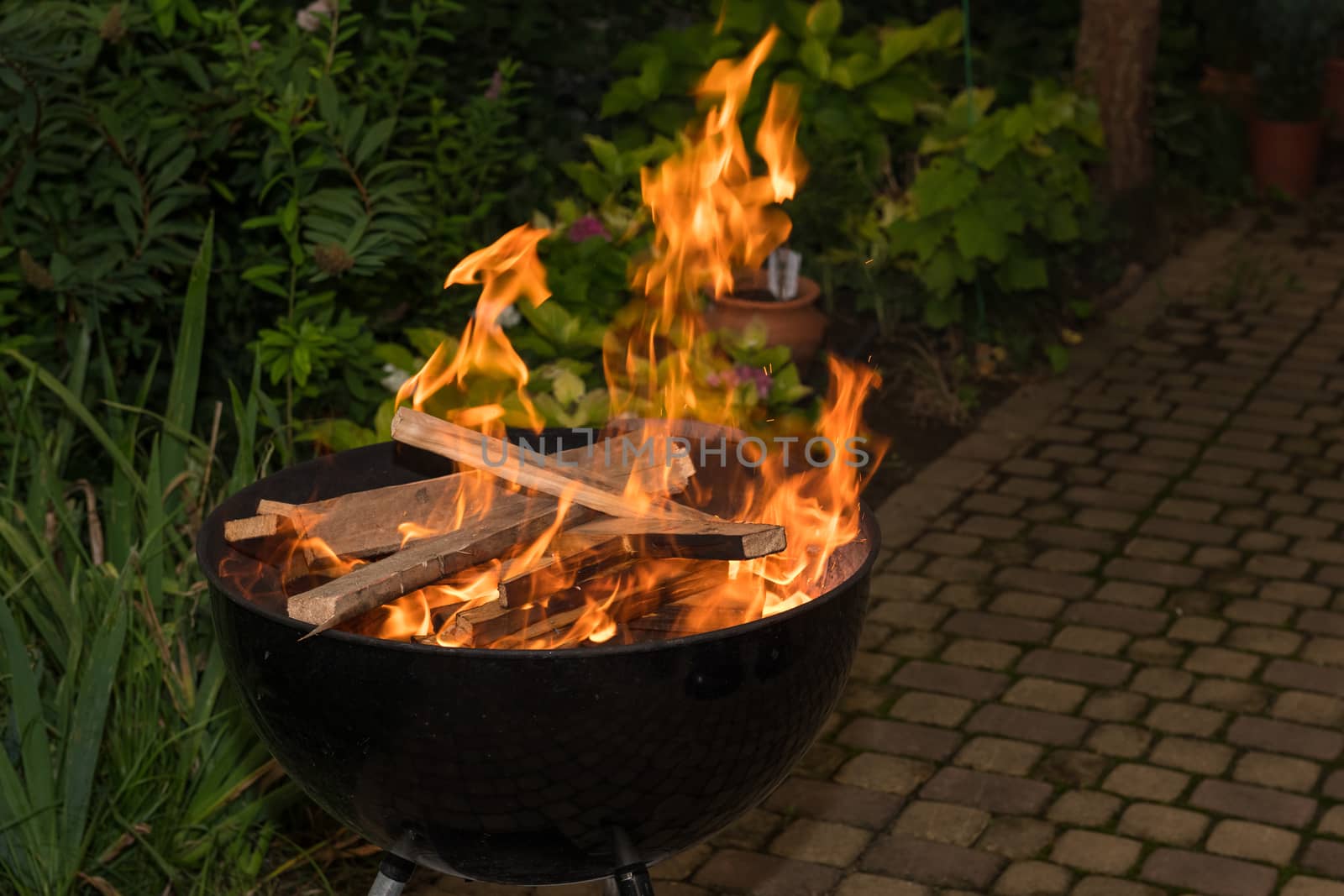 Close-up of blazing fire in BBQ grill at evening.