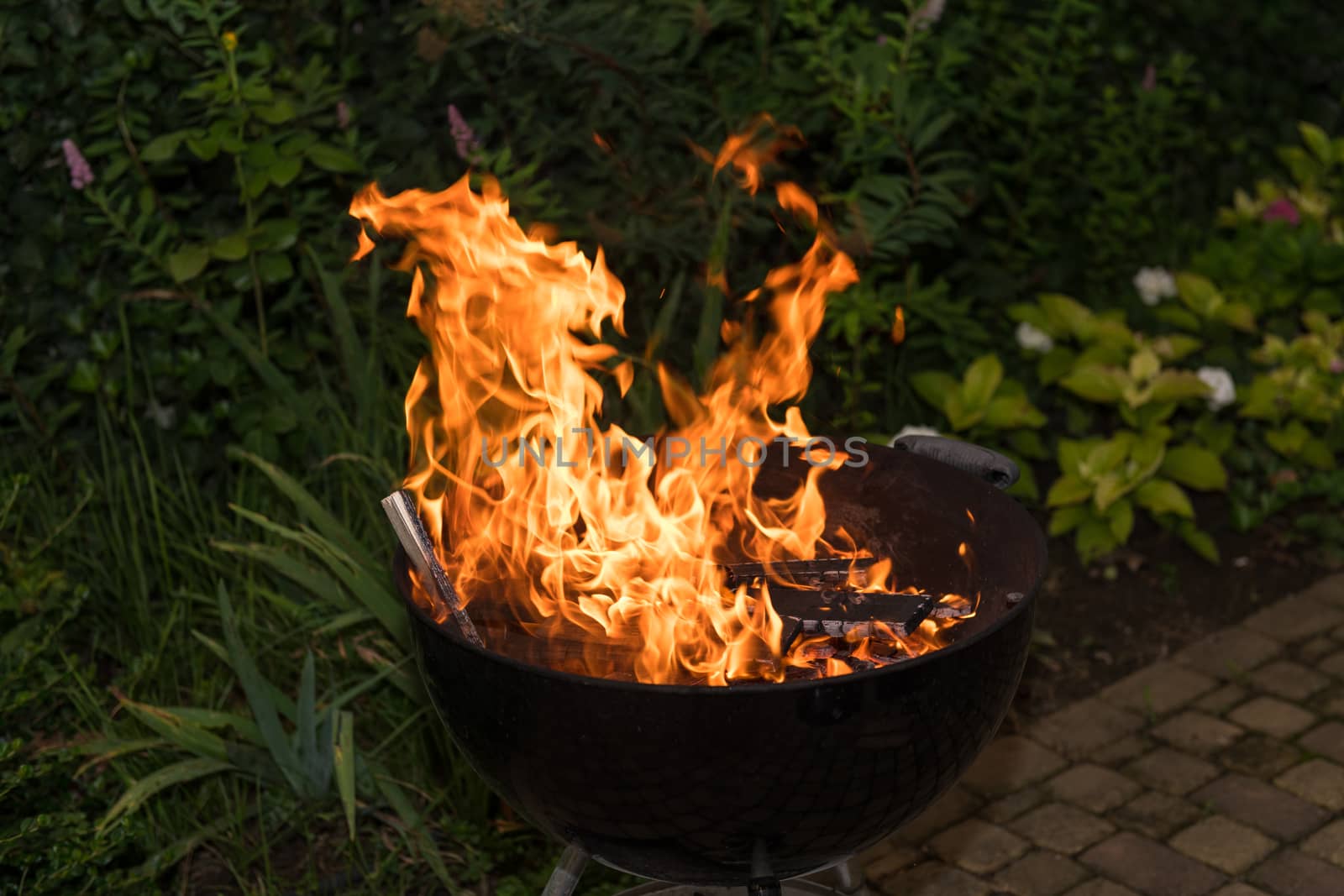 Close-up of blazing fire in BBQ grill at evening.