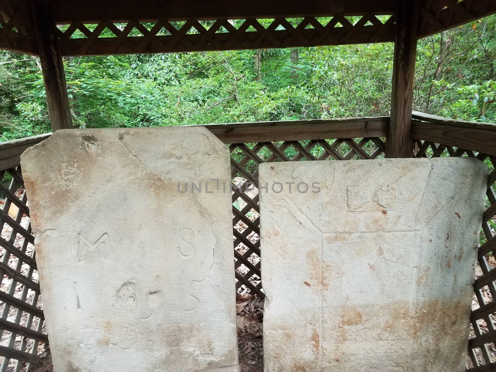 old worn stone gravestones and wood covering by stockphotofan1