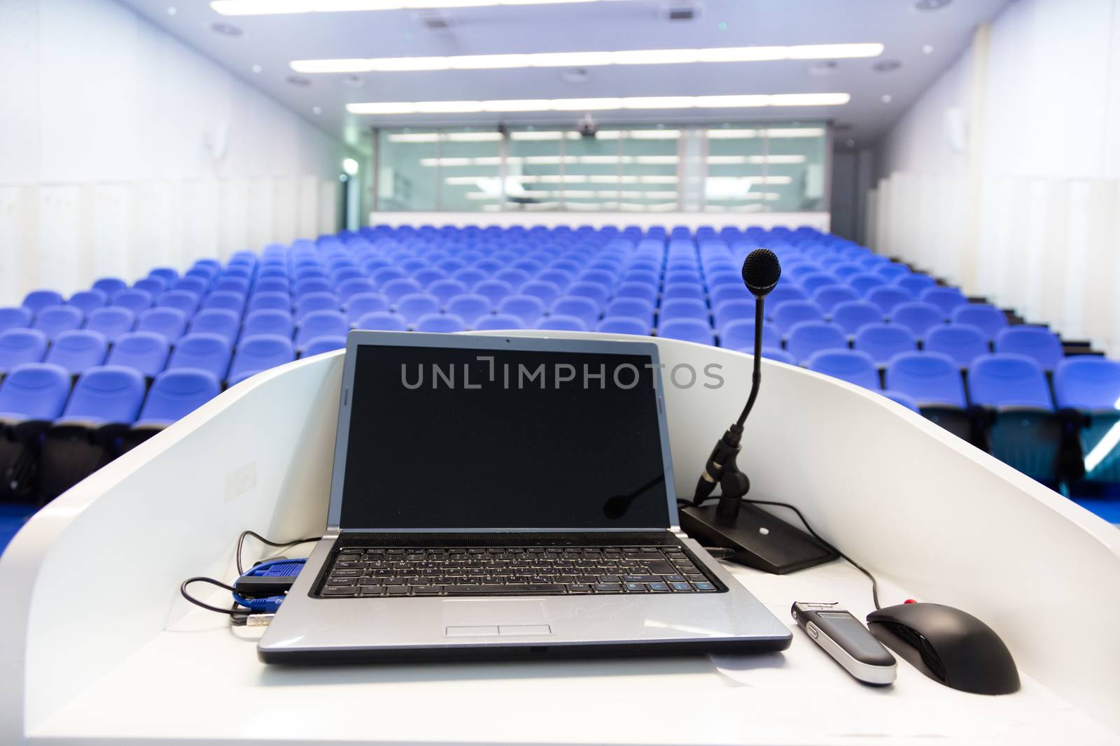 Laptop on the rostrum in conference hall. by kasto