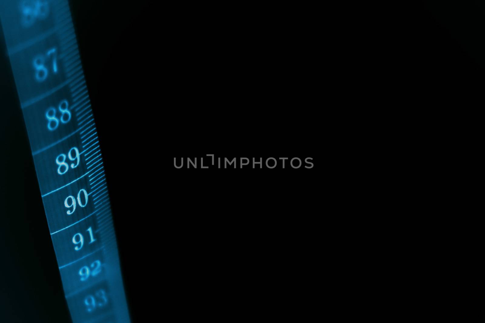 A concept black background with a  tape measure