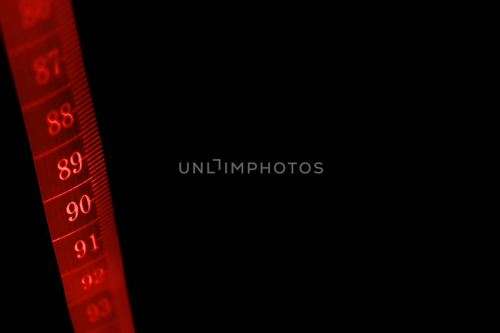 A concept black background with a  tape measure