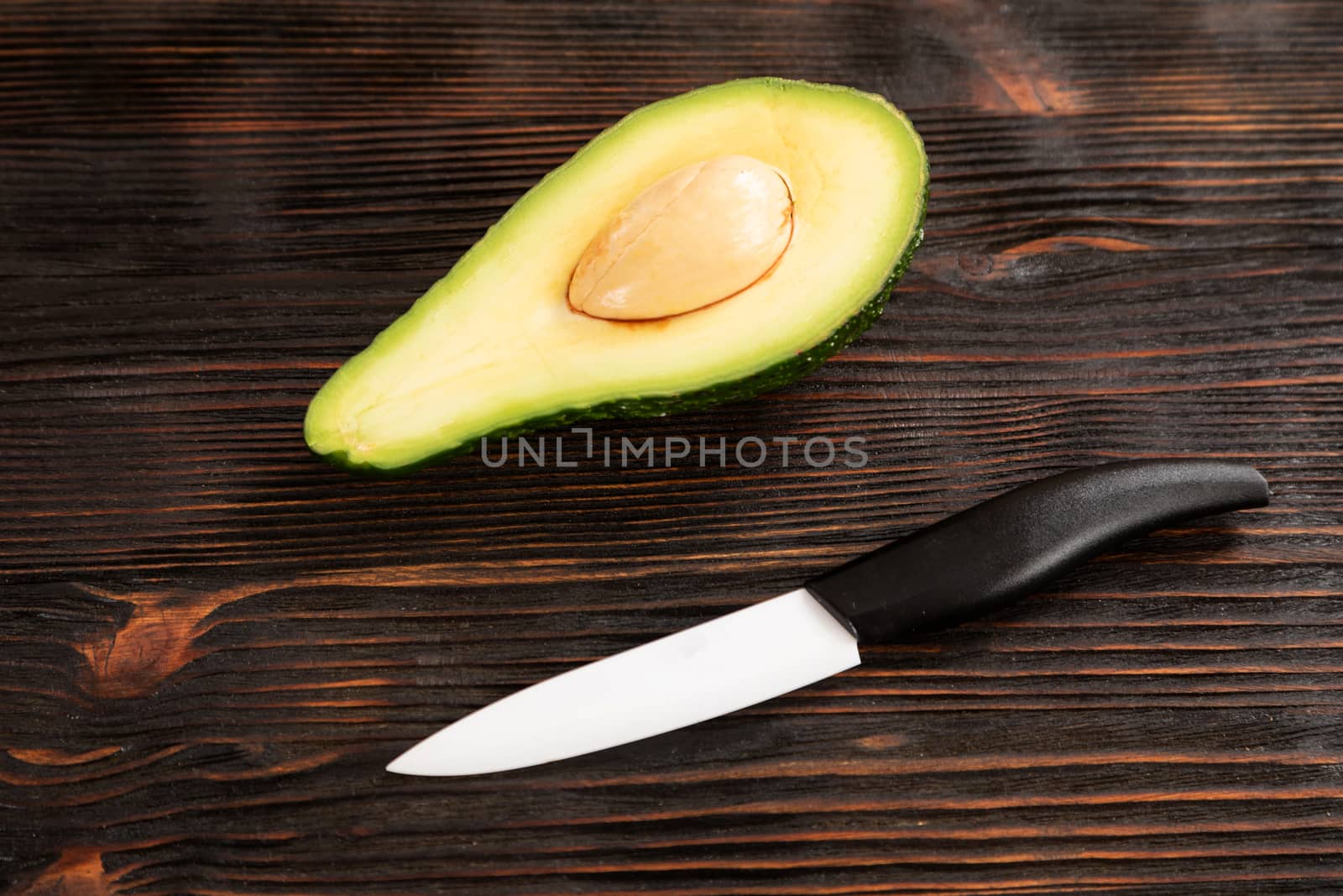 A sliced avocado on a cutting board