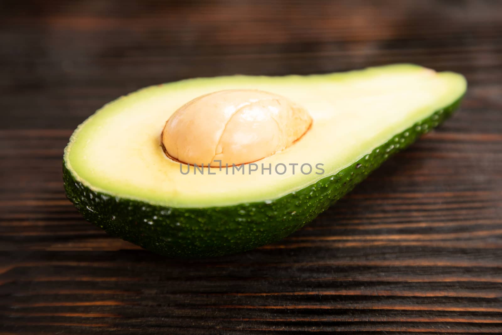 A sliced avocado on a cutting board