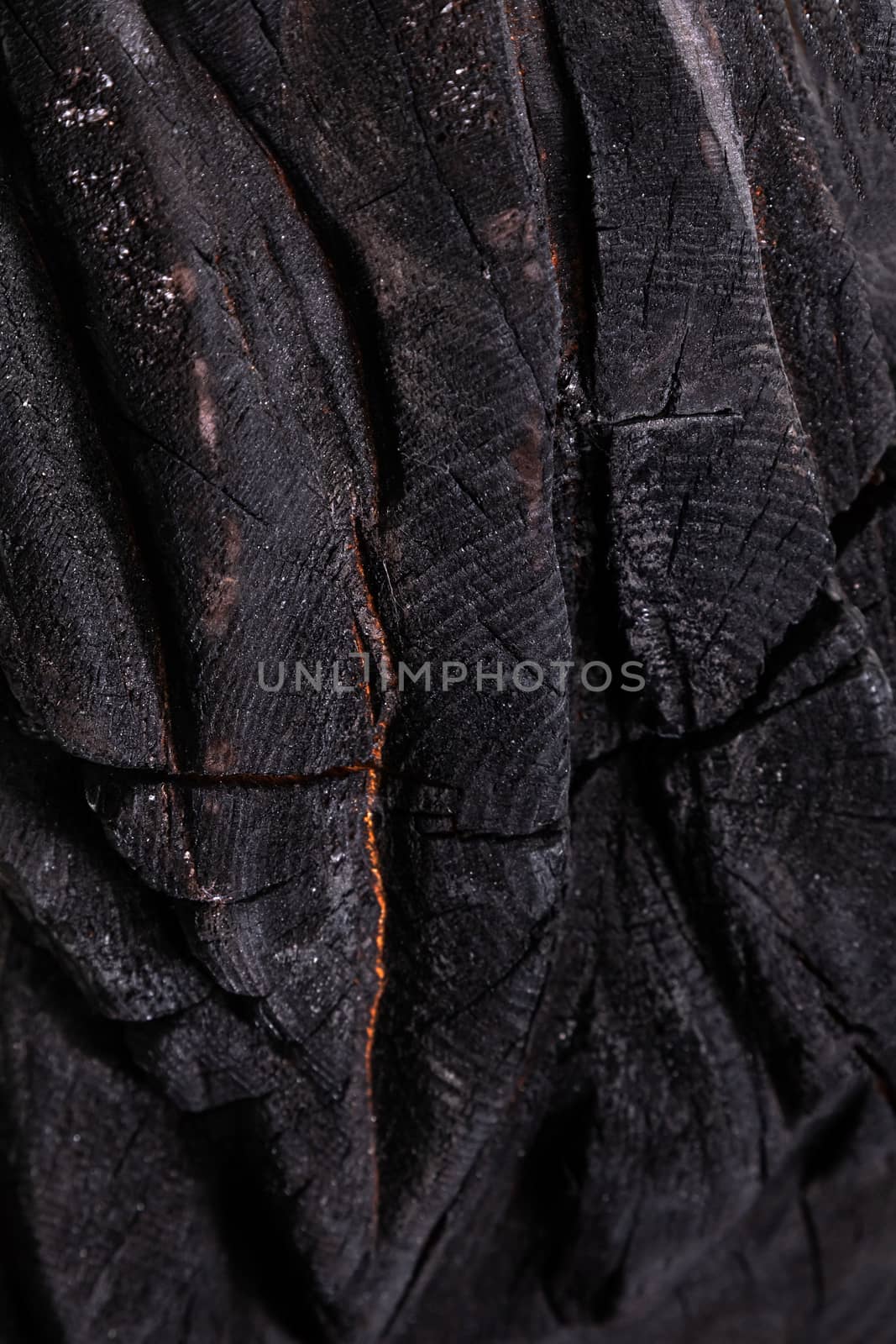 the burned black wooden texture a close up. by sveter