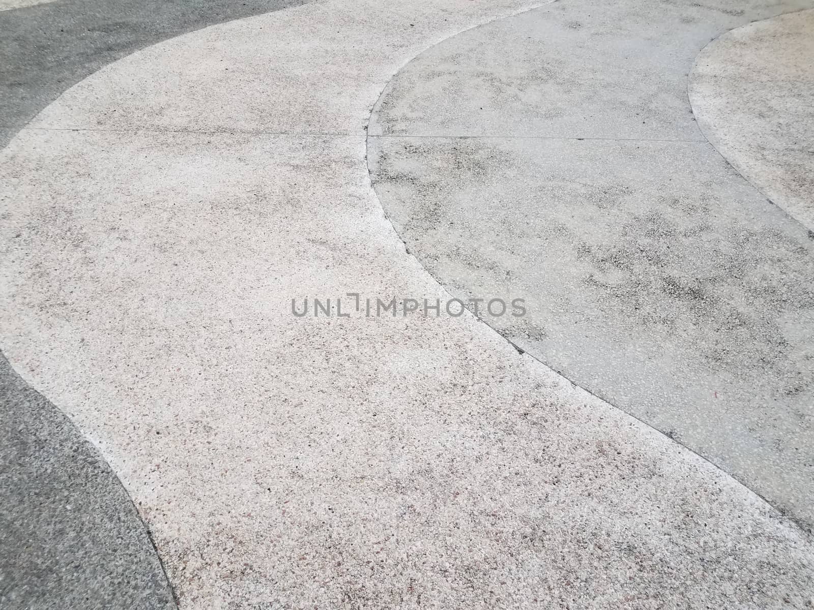 white and grey curved cement sidewalk or ground or floor