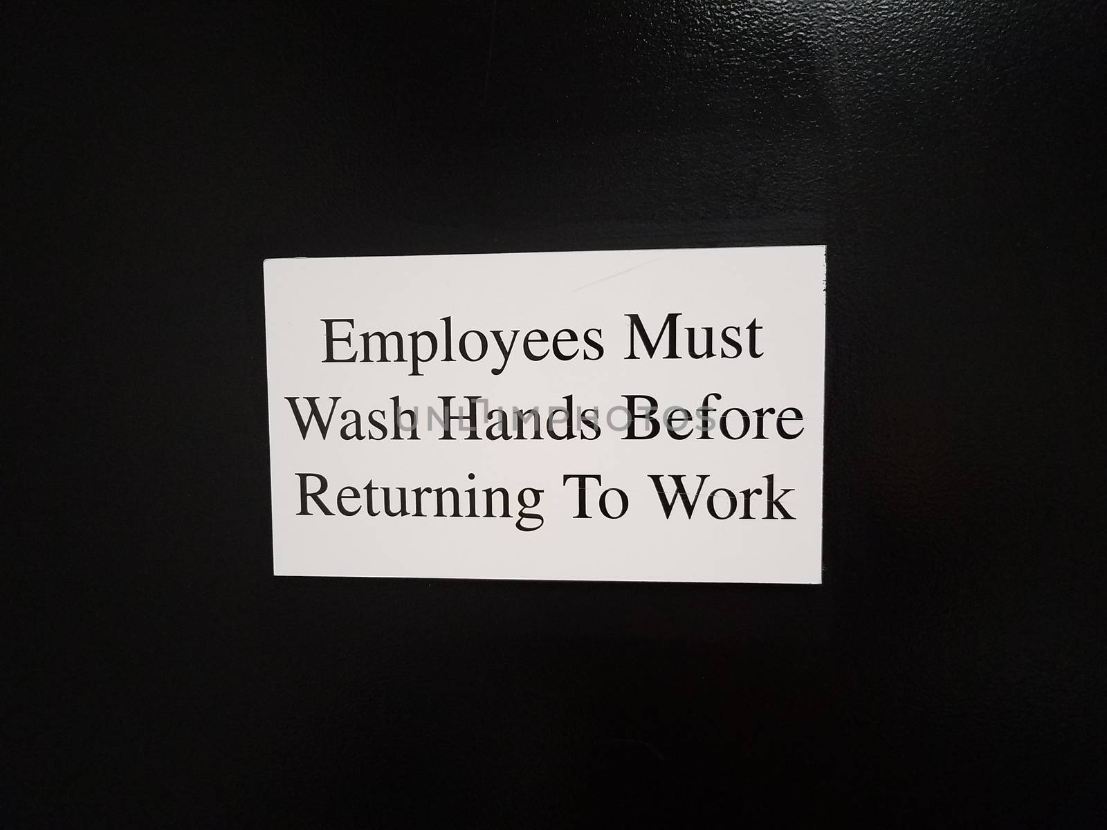 employees must wash hands before returning to work on black wall or surface