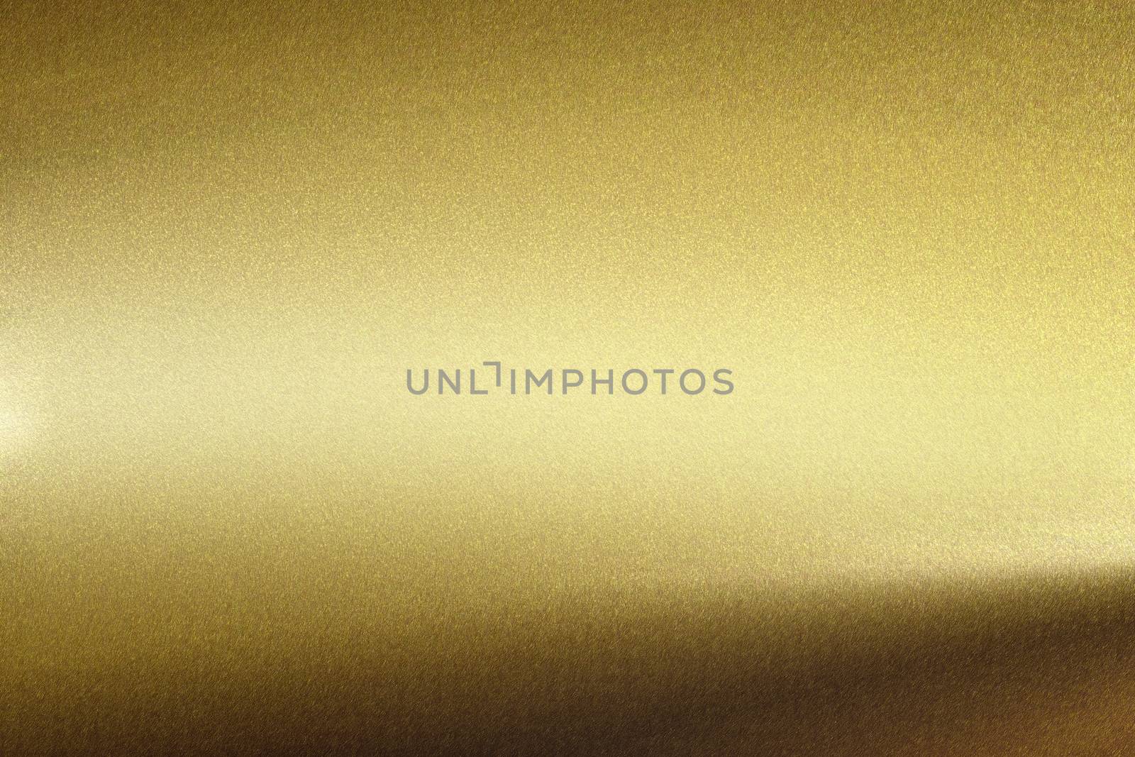 Light shining on rough gold metal wall, abstract texture background