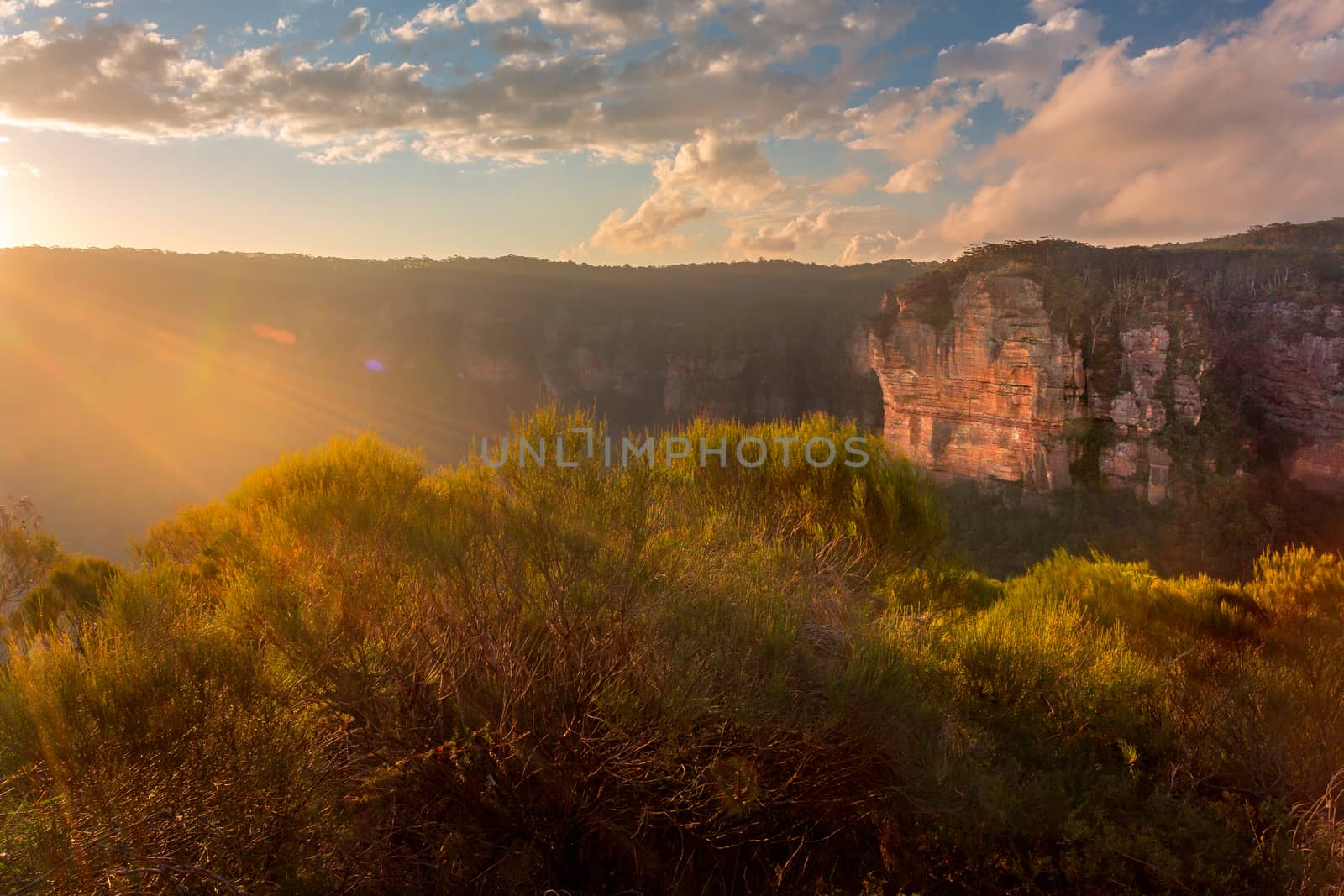 Sunbeams streaming in onto Blue Mountains escarpment cliffs at Katoomba
