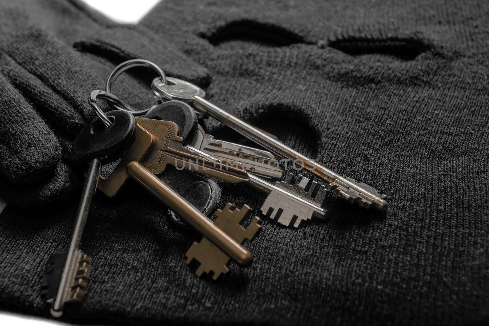 keys of the robber for opening locks, balaclava and gloves close-up