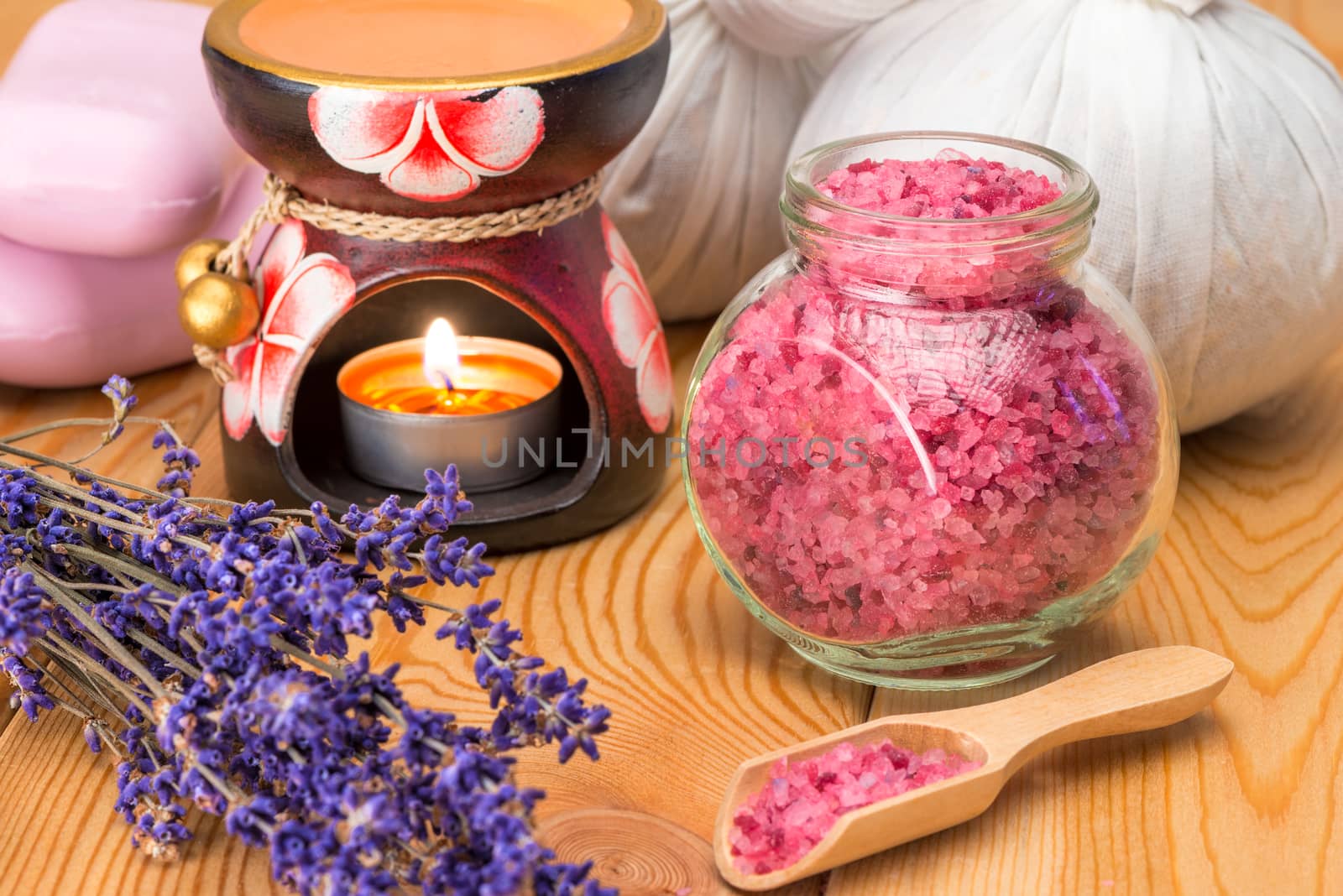 bunch of dried lavender, sea salt and burning candle spa objects close up