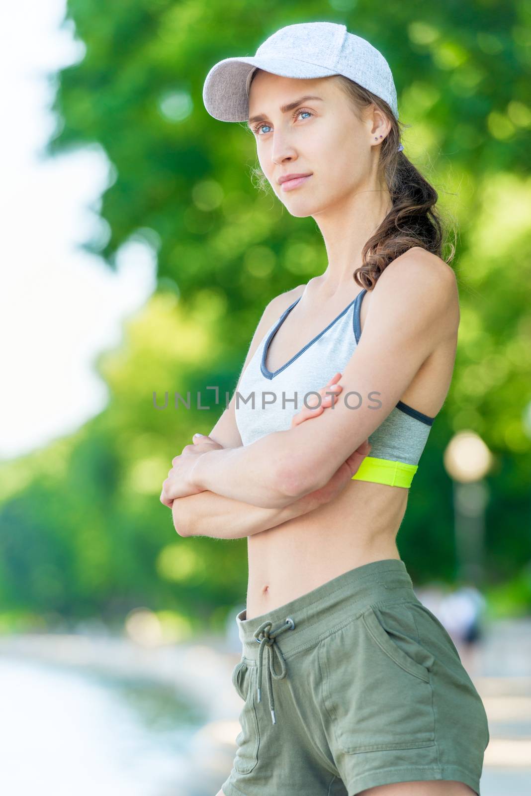 Vertical close-up portrait of a happy athletic girl who poses on by kosmsos111