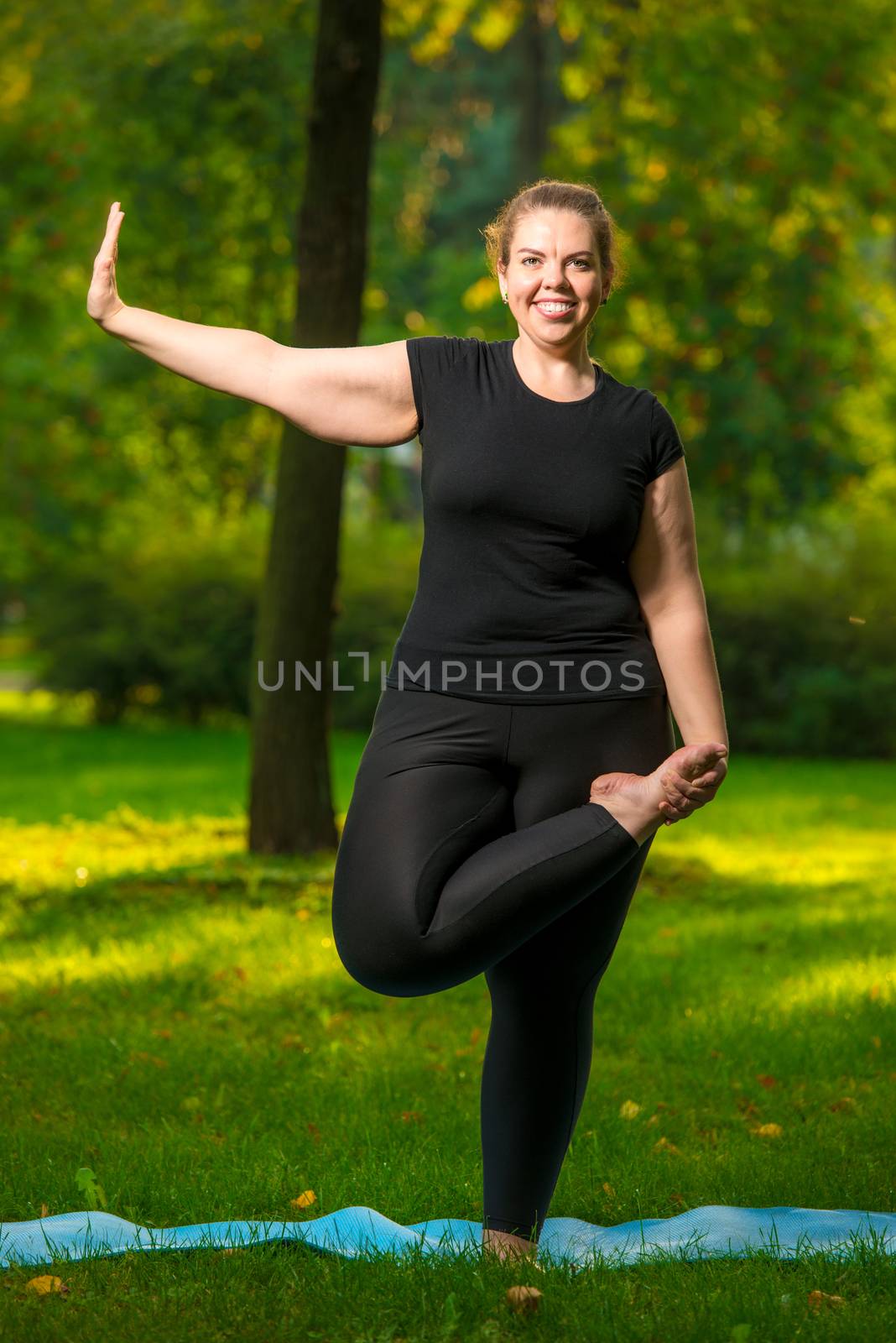 Overweight woman stretching in the park. by kosmsos111