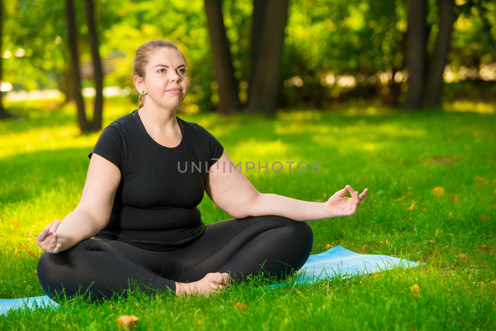 meditation in the park, a portrait of a focused model over size during a yoga workout