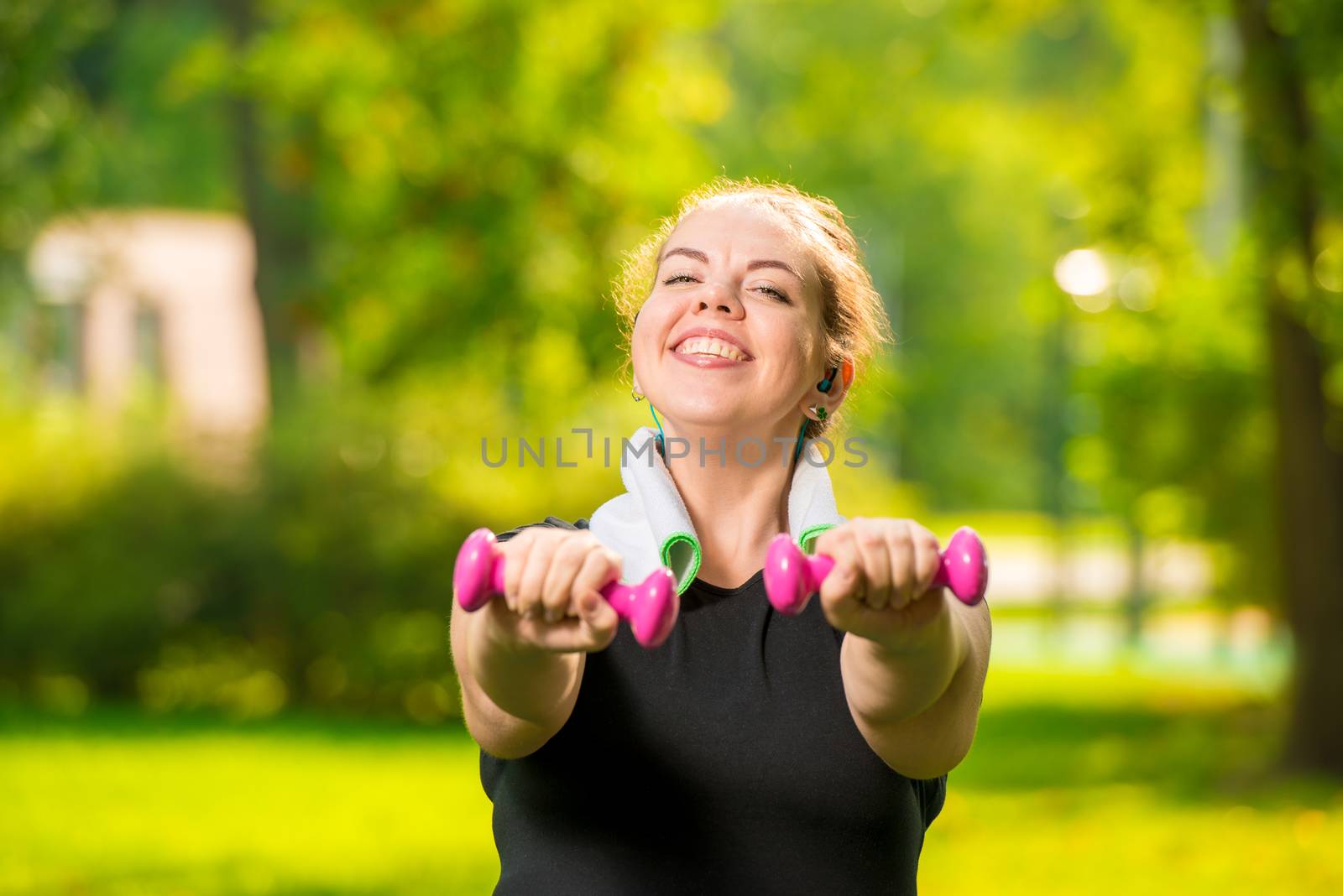 horizontal portrait of a smiling plus size woman with dumbbells by kosmsos111