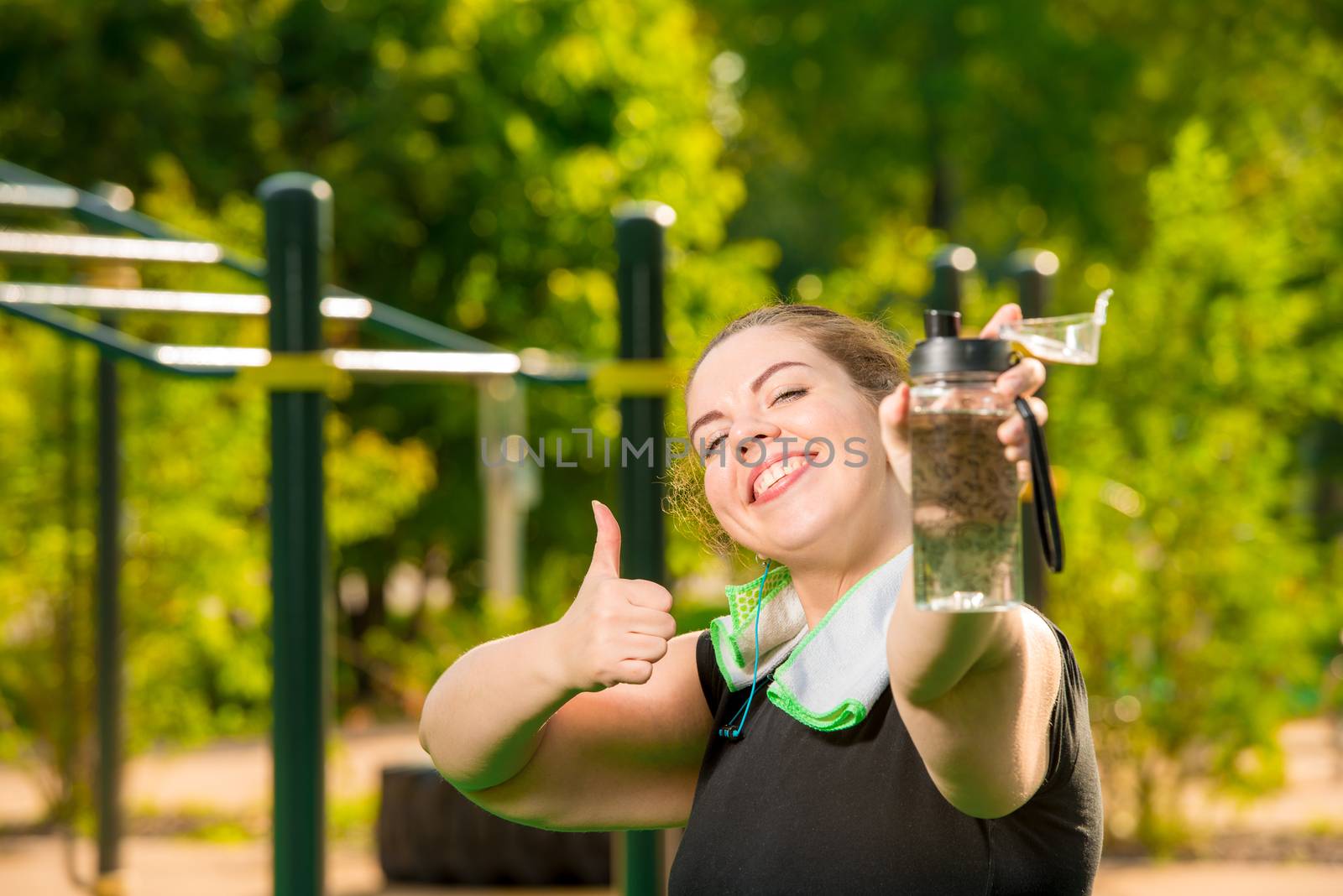 happy oversized woman with bottle of water smiles, portrait afte by kosmsos111