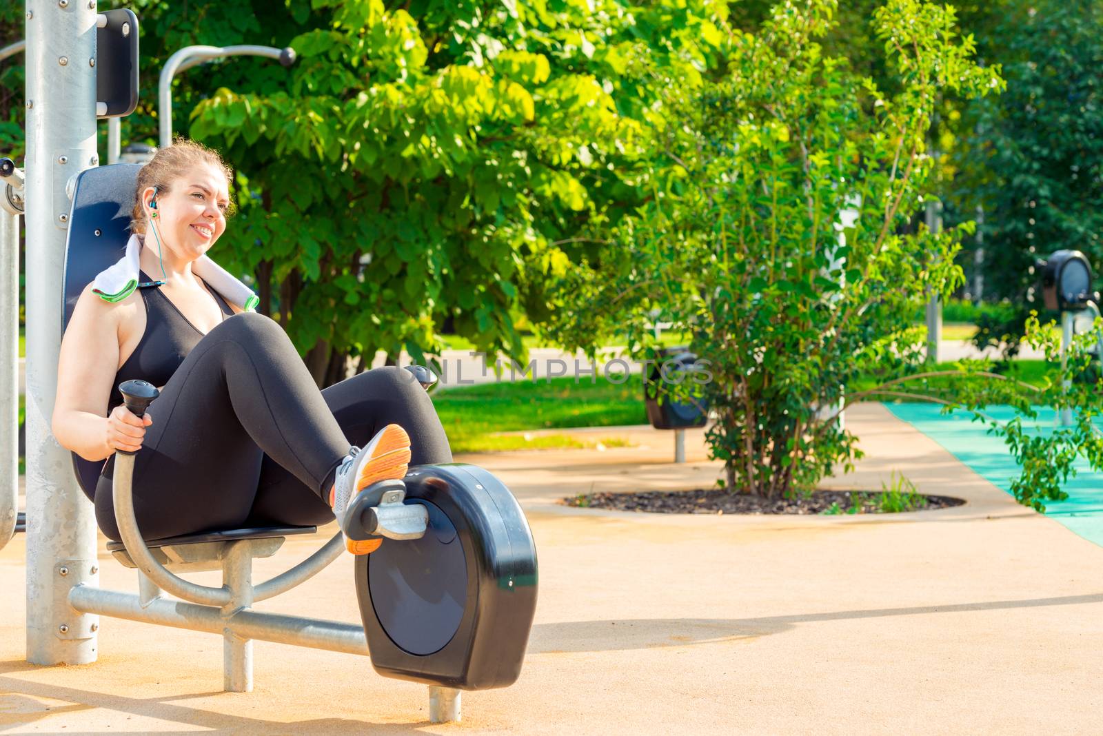 active oversized woman doing exercise on a stationary bike in a by kosmsos111