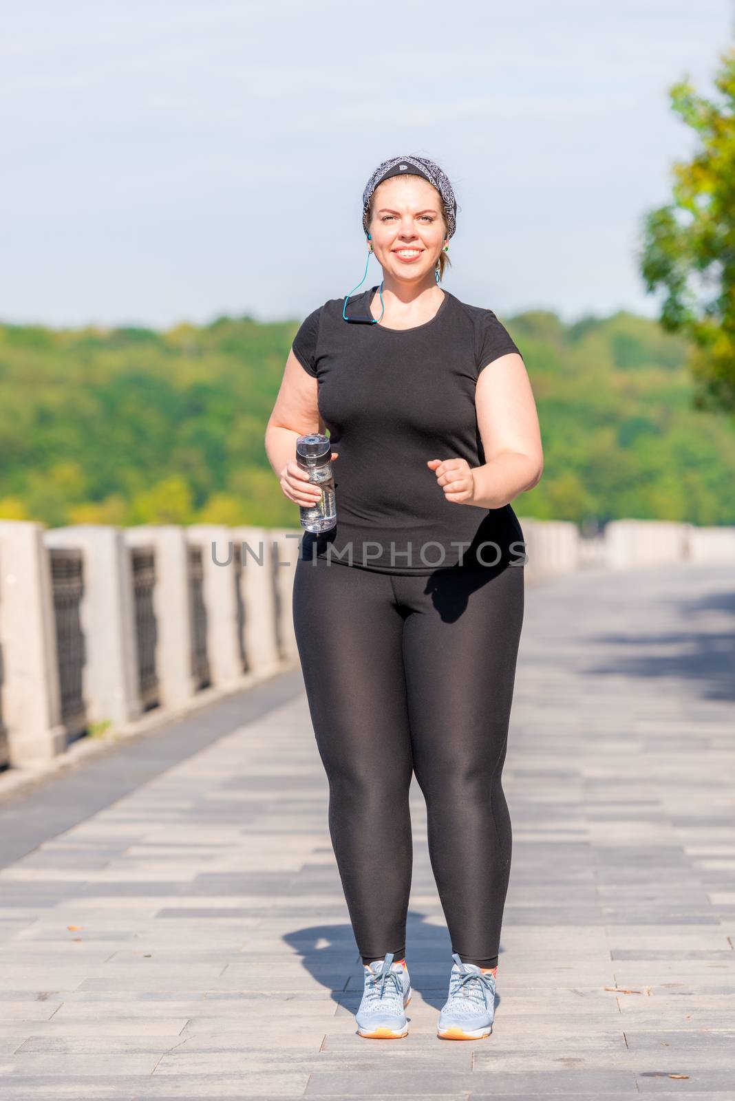 over size woman while jogging in the early morning in the park
