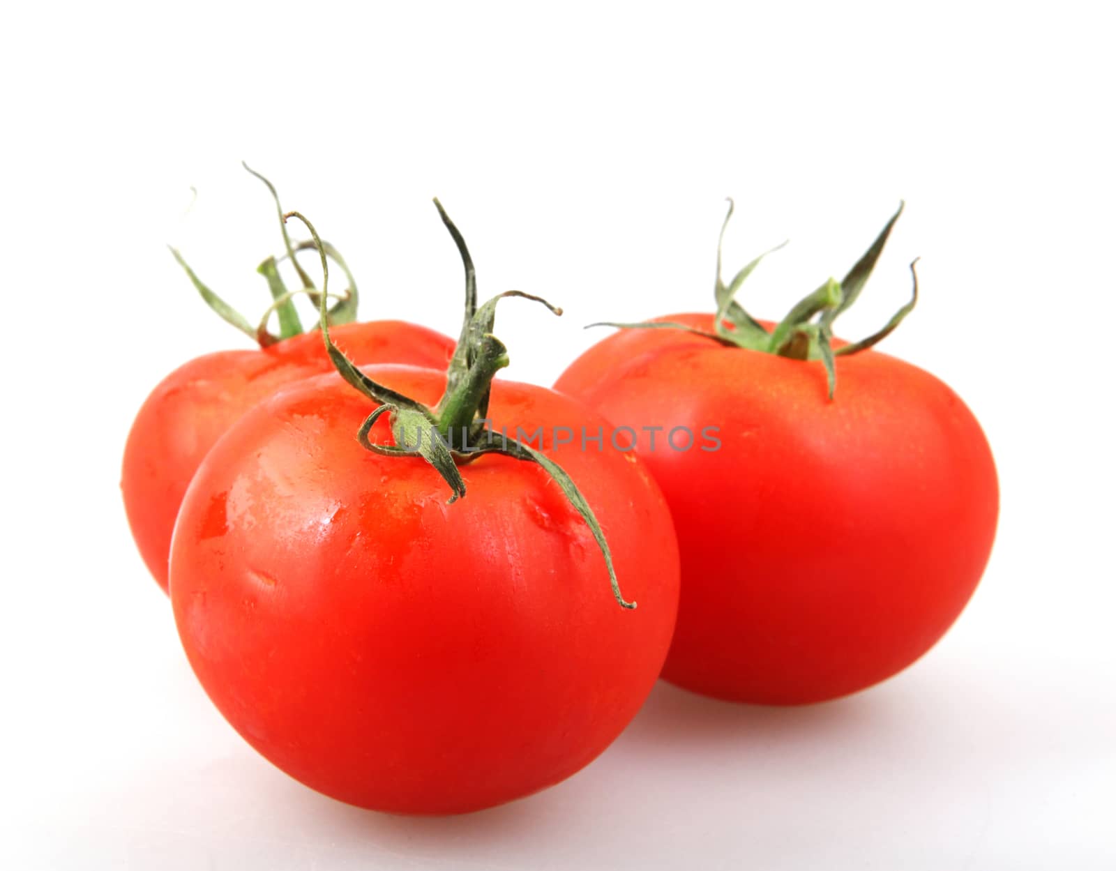 Close-Up Of Red Tomato On White Background by nenovbrothers