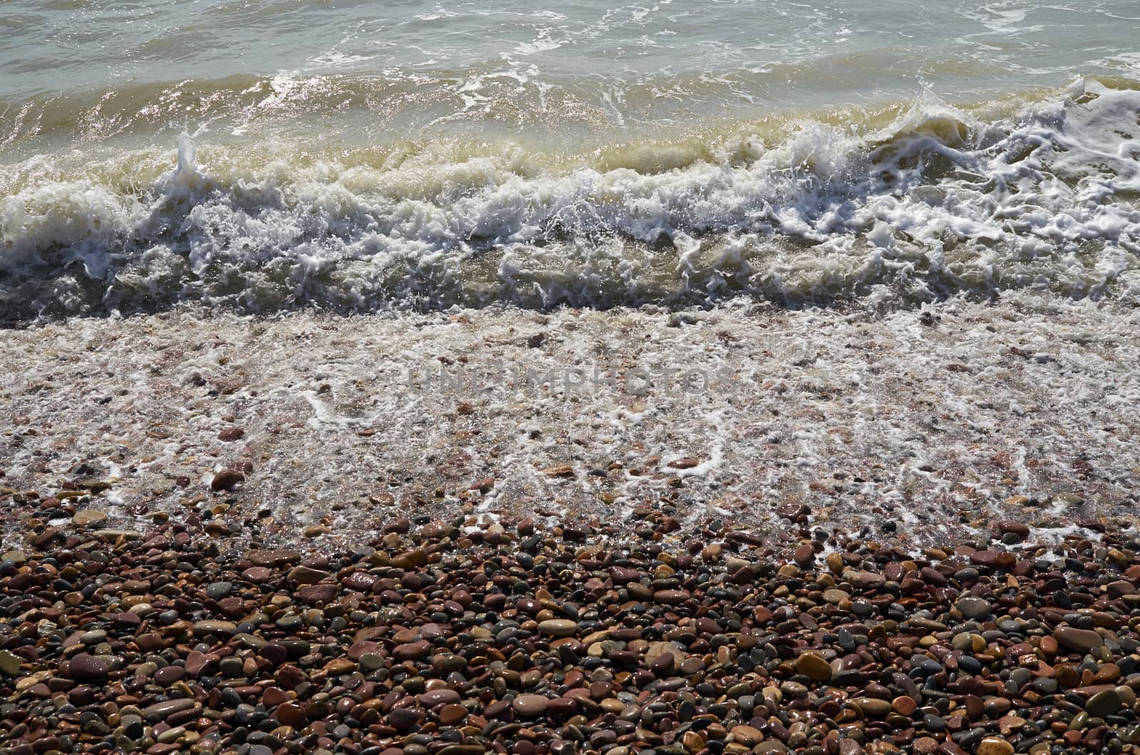 Detail of waves reaching the shore of the beach